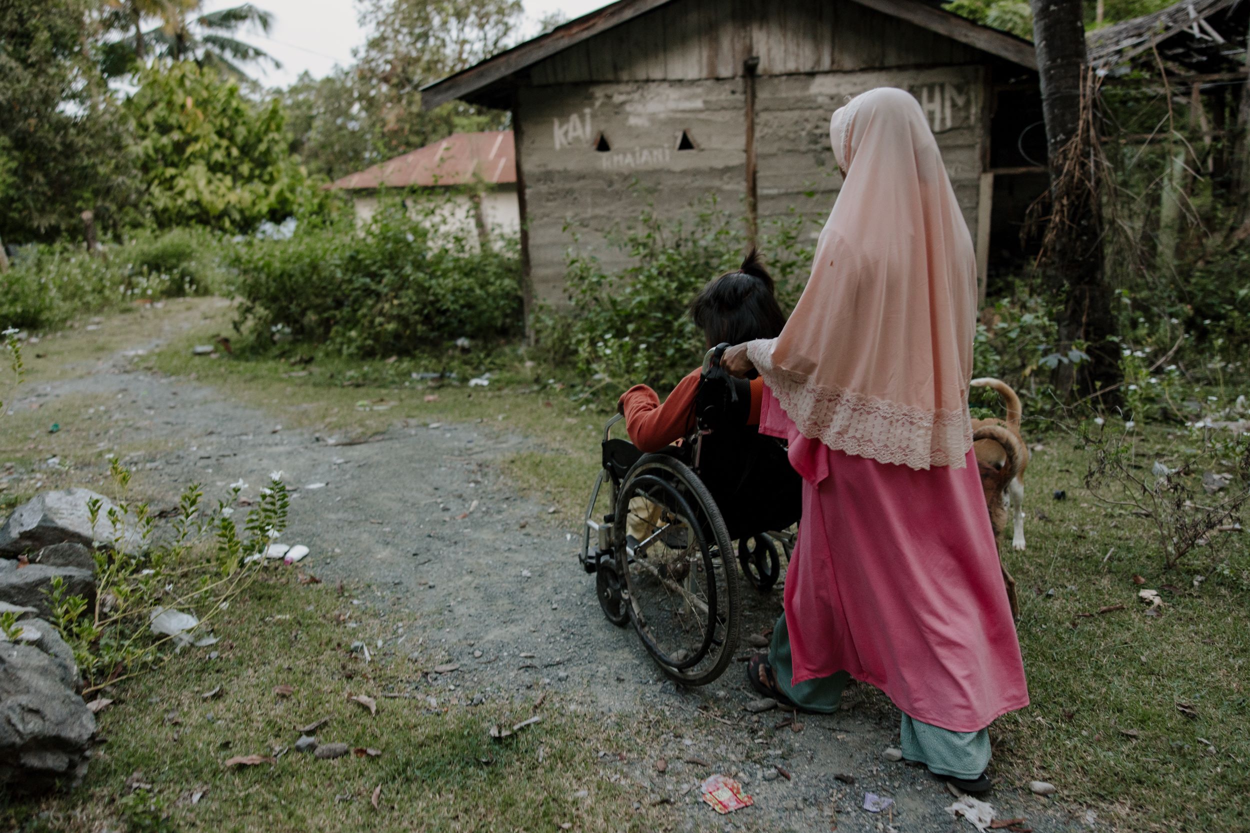 Mum pushing her daughter in a wheelchair