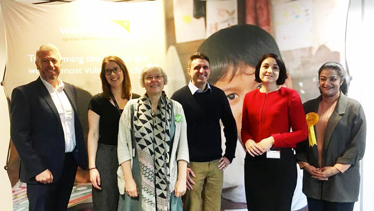 Six people in the UK gather in a room for general election hustings