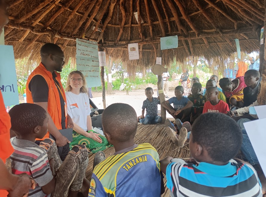 Zambian children with World Vision staff