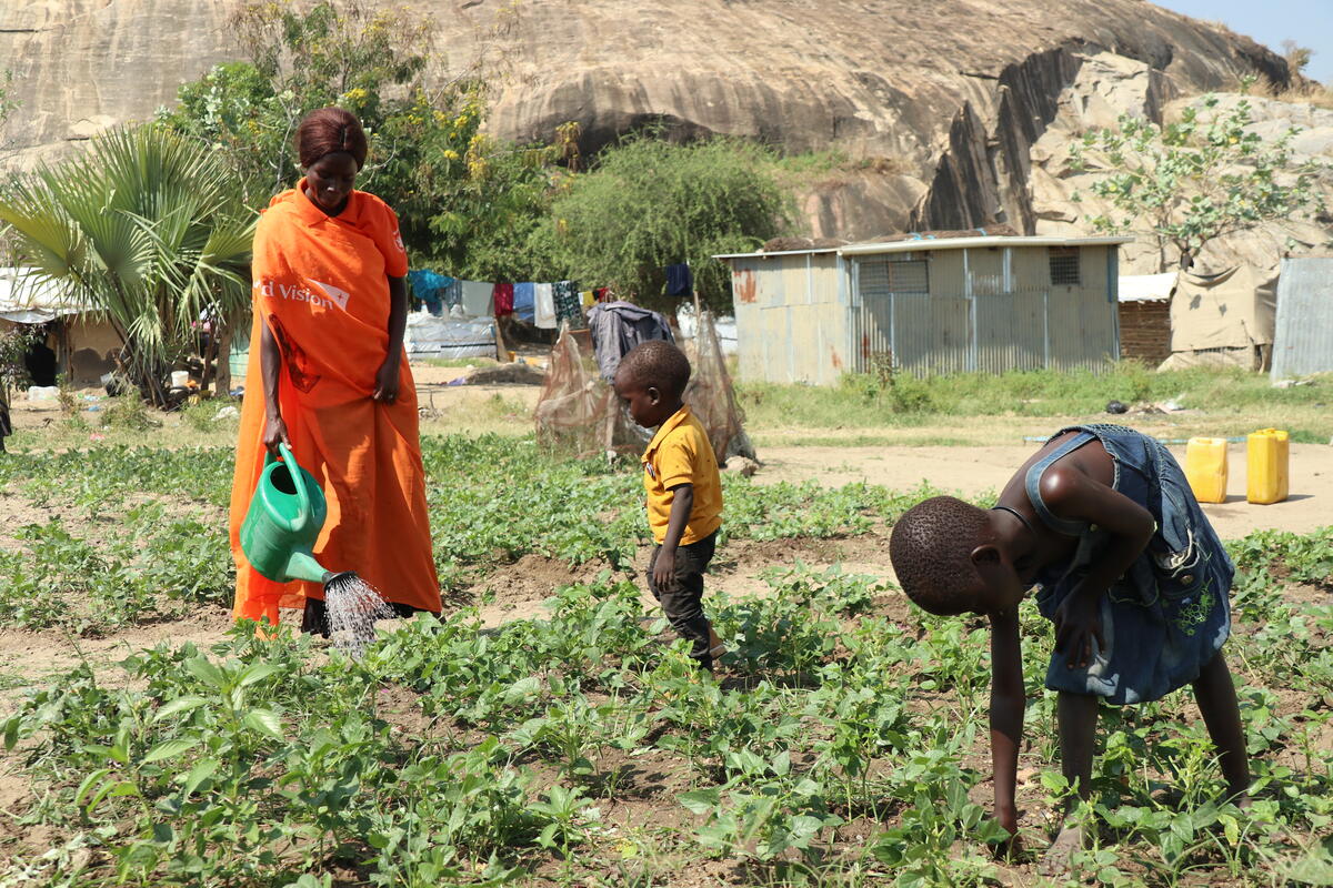 Woman and children watering crops