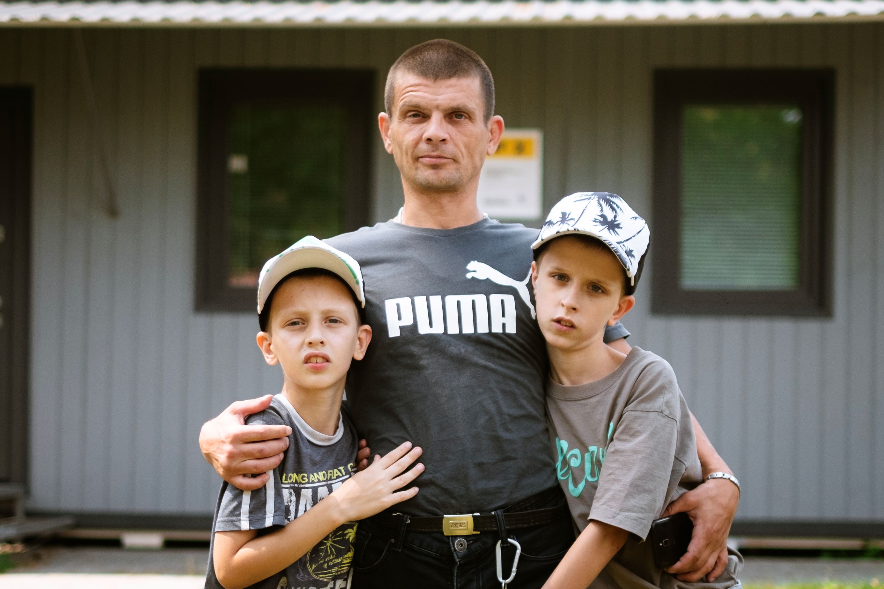 Father Hennadiy, pictured with his two boys, who have special education needs, credits a day centre with helping his son recover from trauma