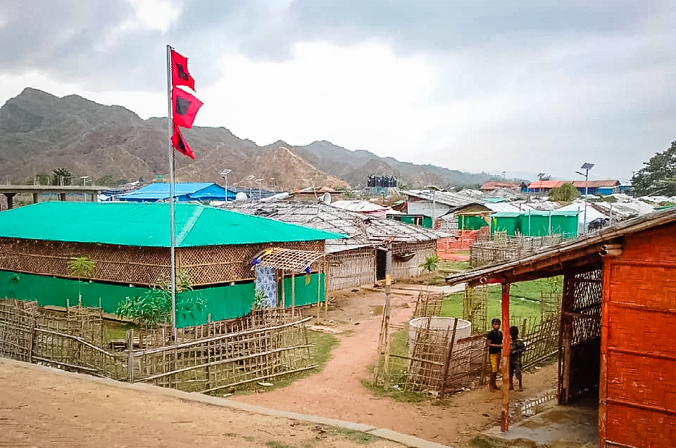 A red flag flying above a building in the refugee camp indicating that families need to get to shelter in the cyclone shelters.