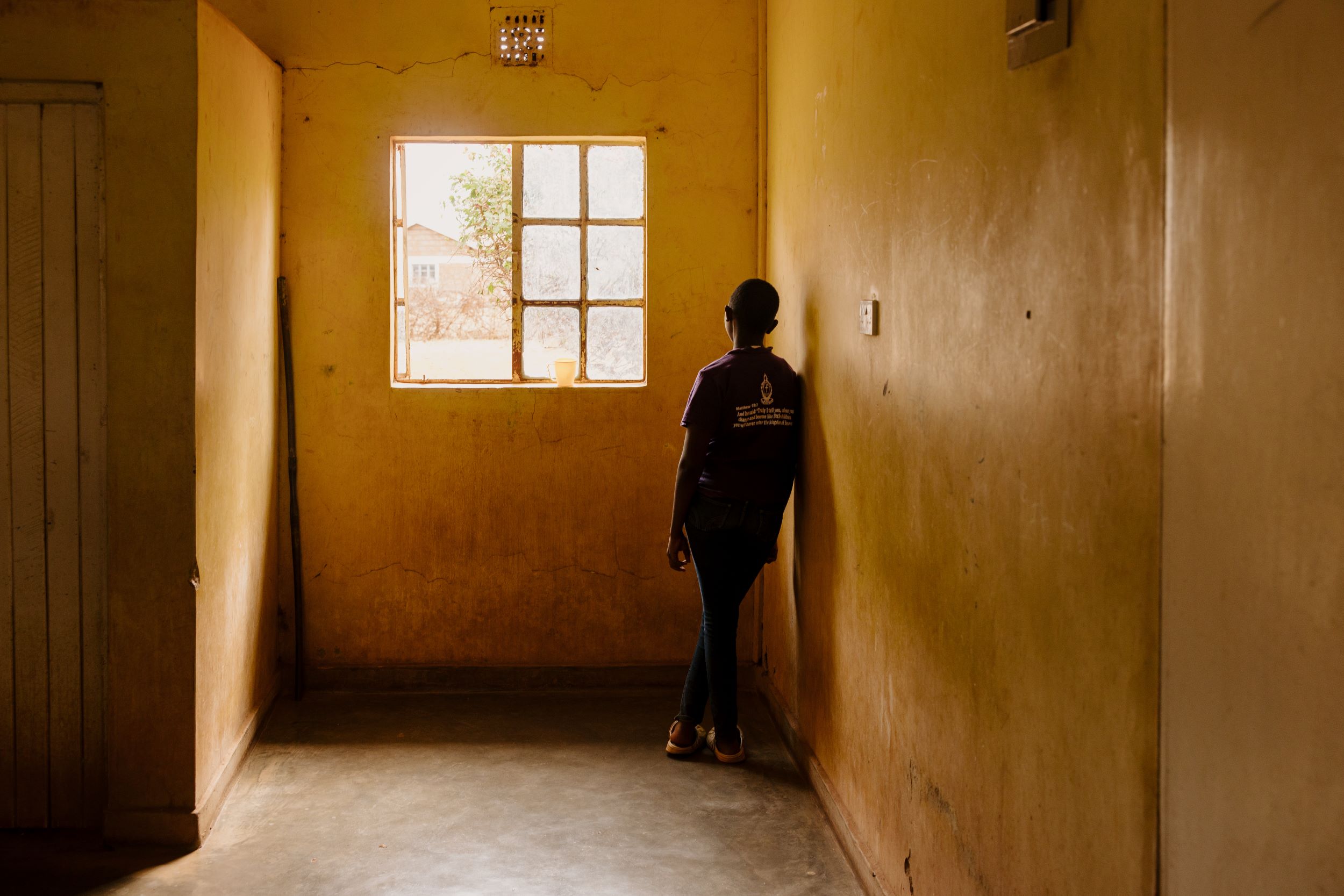 Kenyan girl staring out of a window