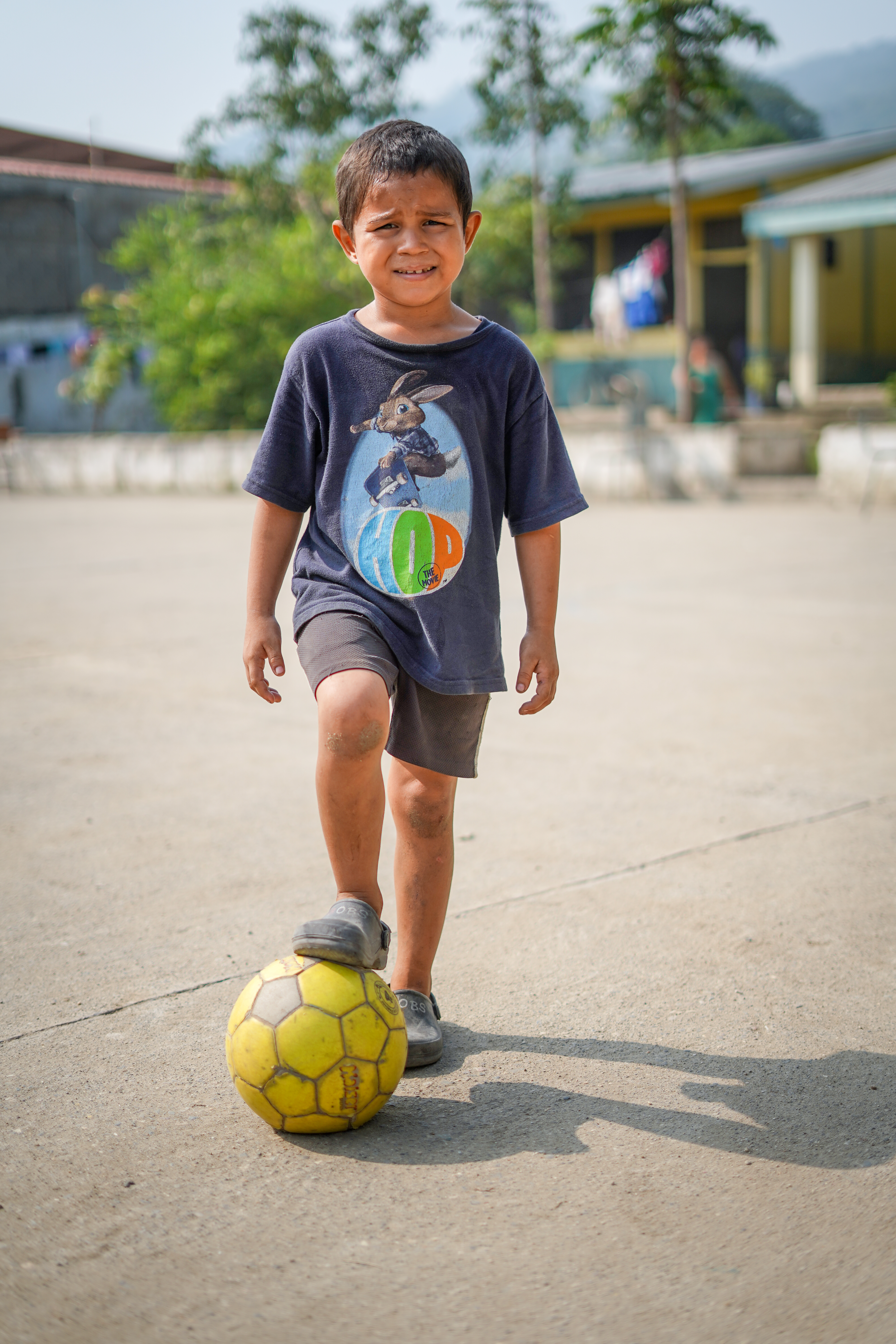 Omar with his football, which he's able to play with at the child friendly space.