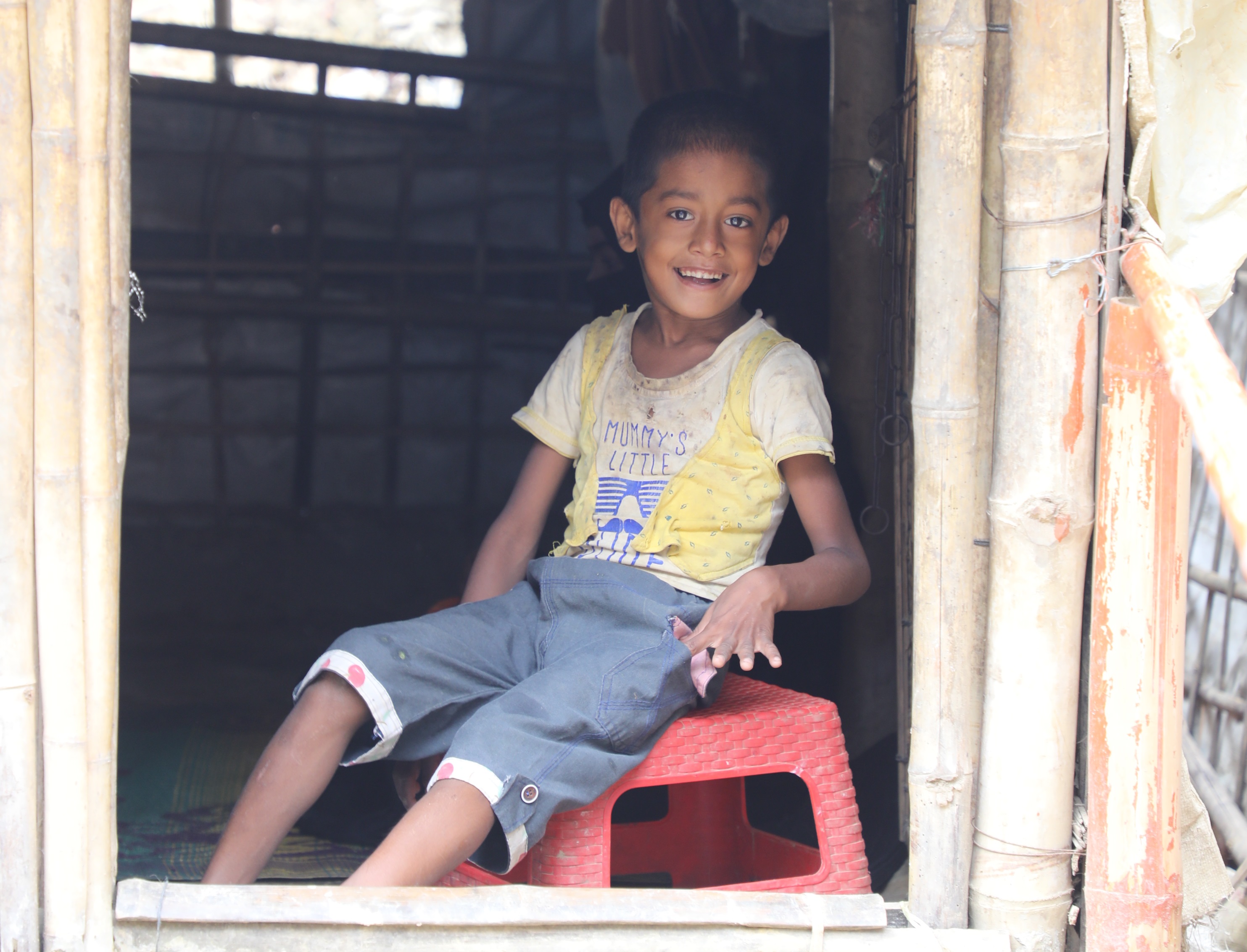Happy Ares sitting in the doorway of his house. He is now able to go outside by himself.