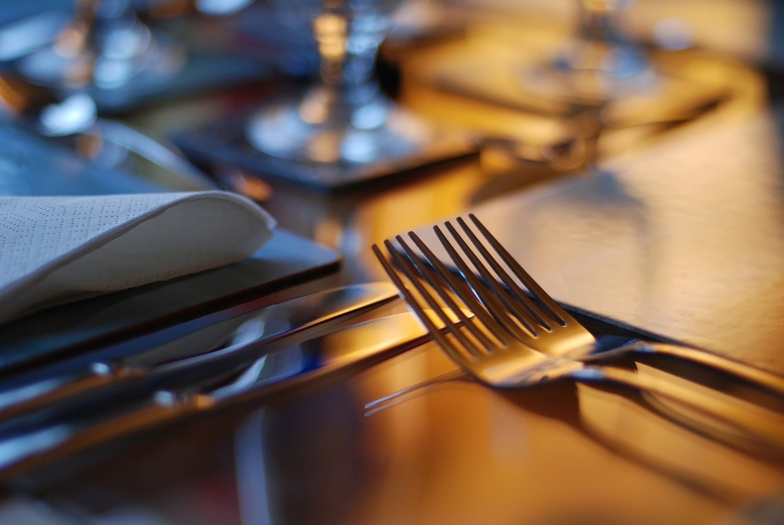 A close up of a knife and fork laid on a table
