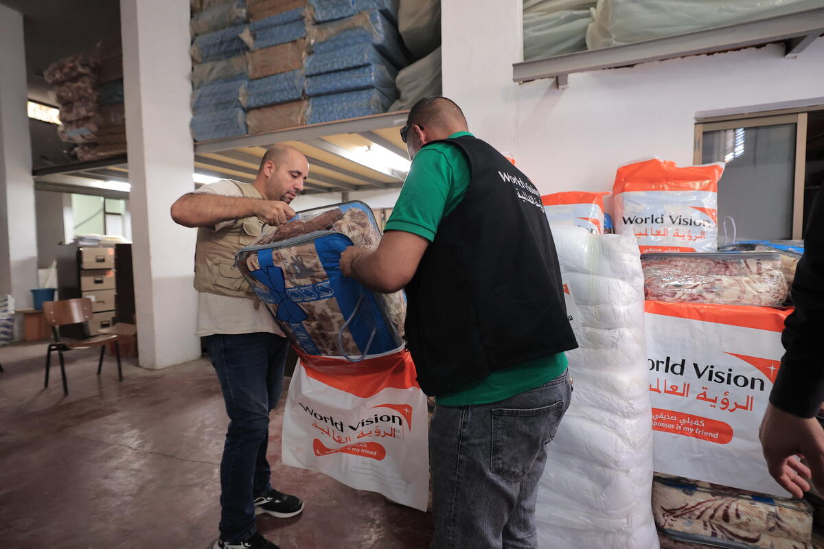 World Vision workers pack supplies in a warehouse 