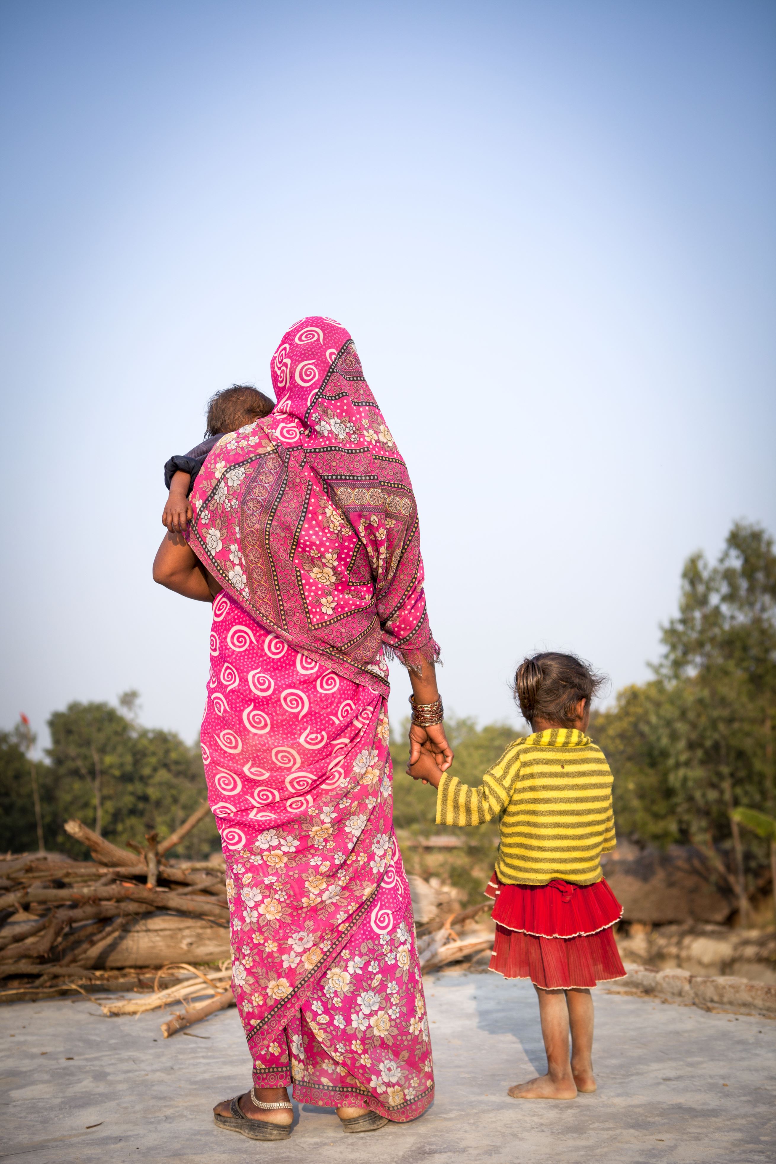 Woman with back to camera with her two children