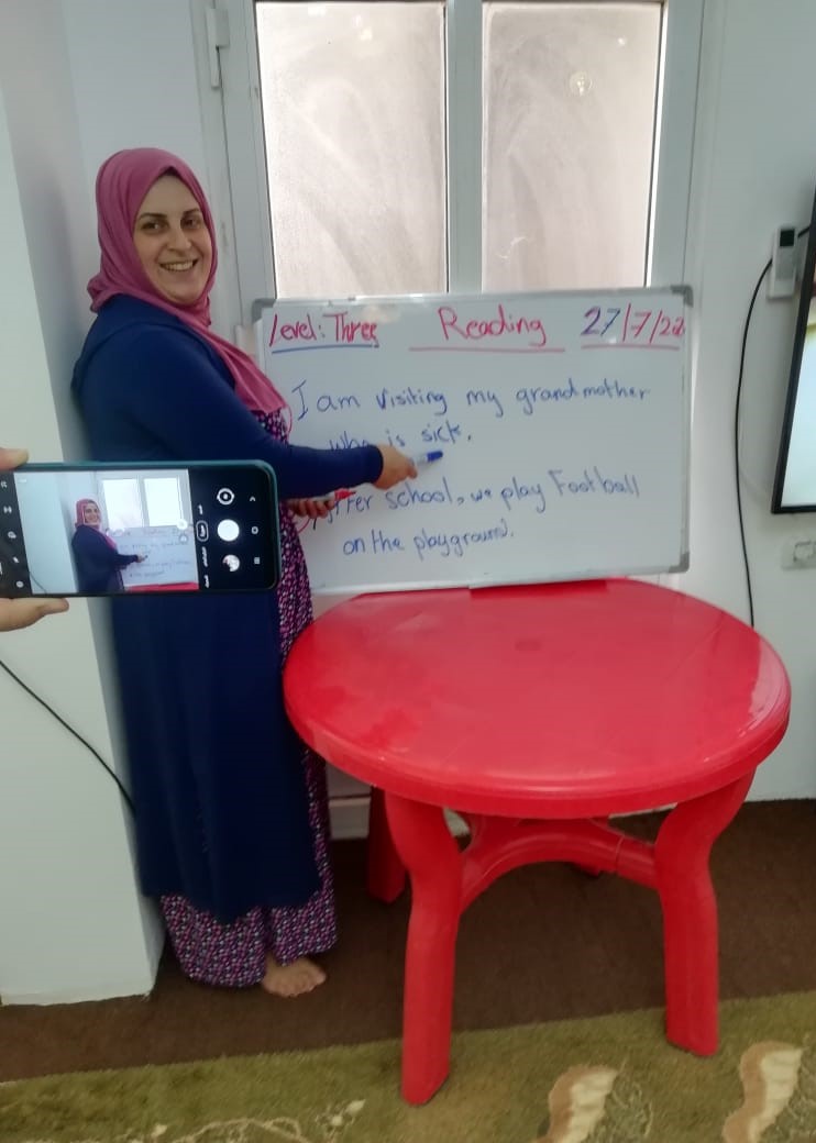 Woman in Lebanon teaches a lesson during coronavirus using a whiteboard and a mobile