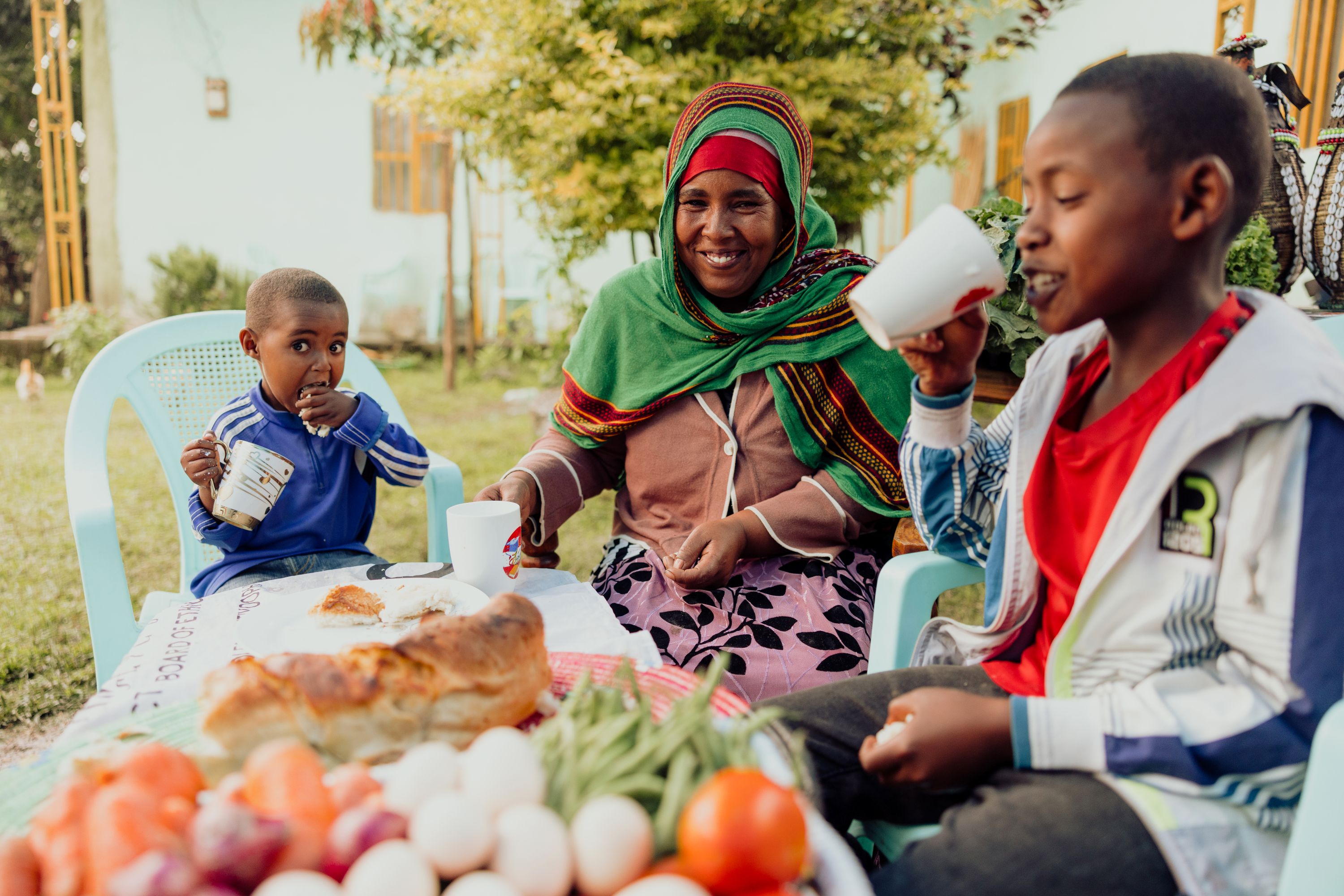Healthy nutritious food laid out on a table for Mensur and Nuredin to enjoy along with their smiling mother, Hindiya