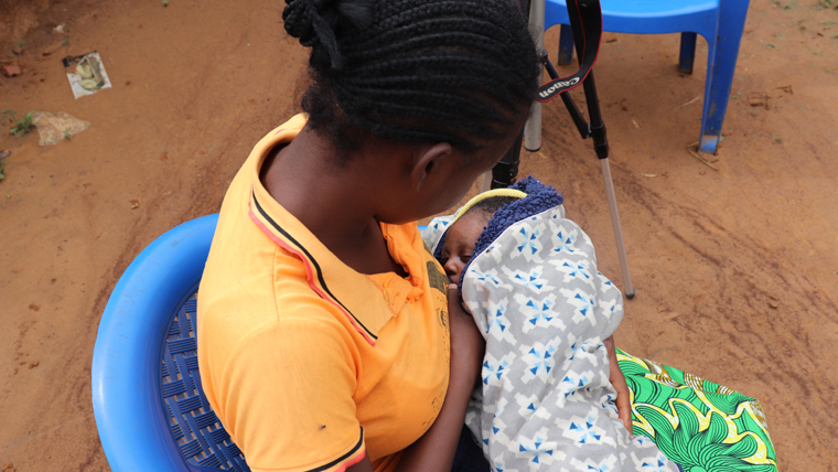 Charlaine, 16, sits and feeds her baby