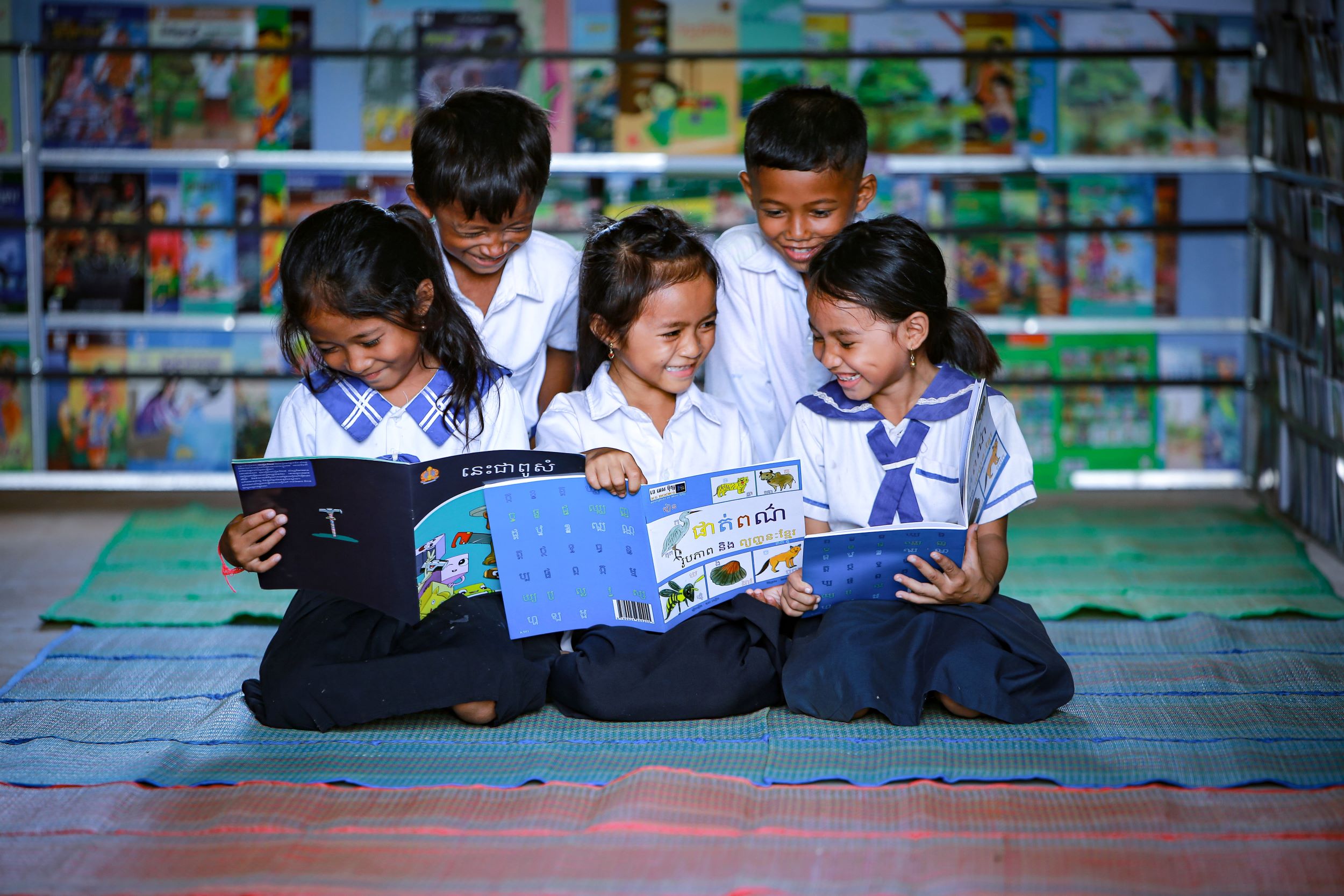 Girls and boys smiling with their books, Cambodia