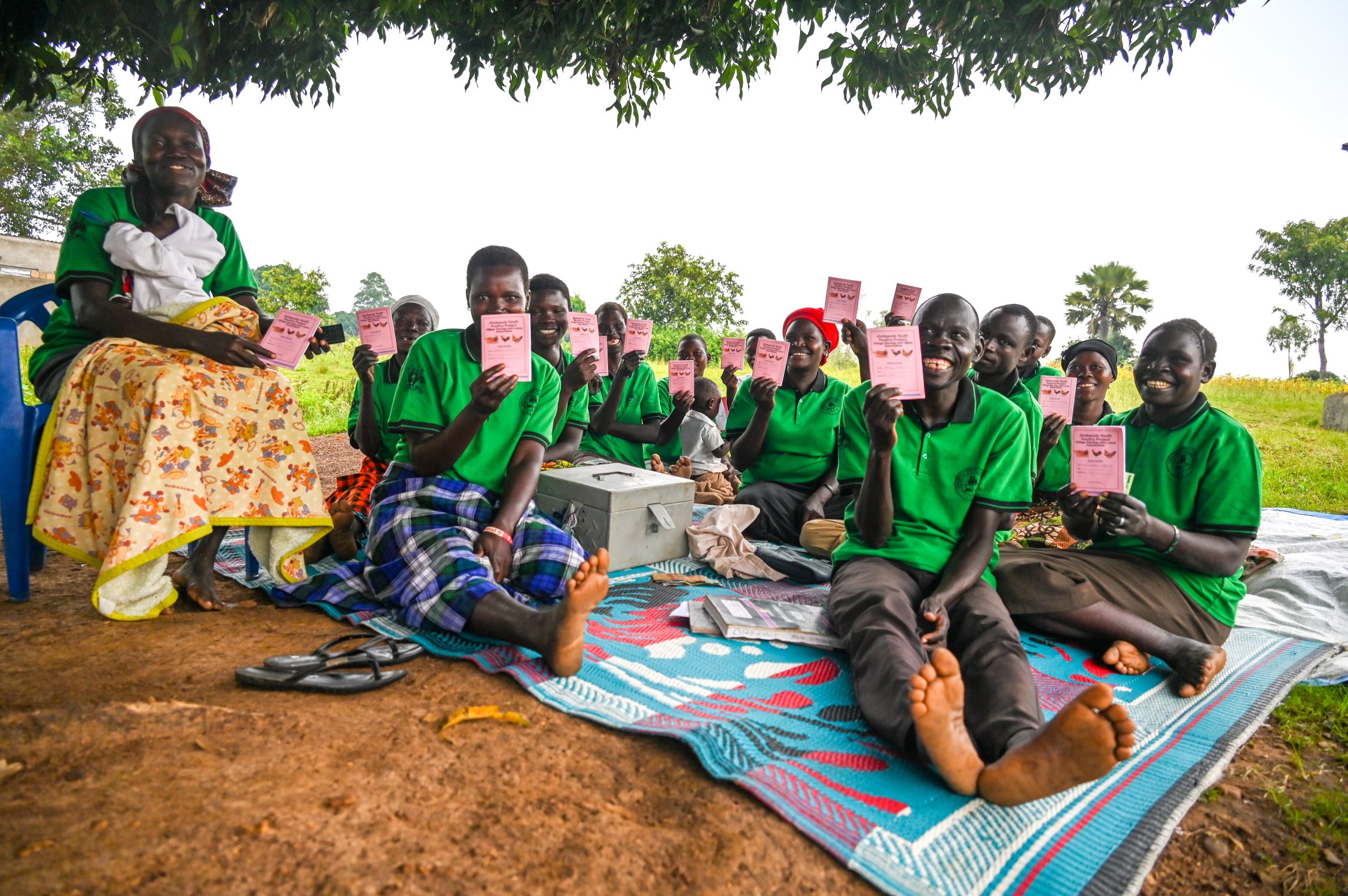 Ugandan women sitting on a mat outside