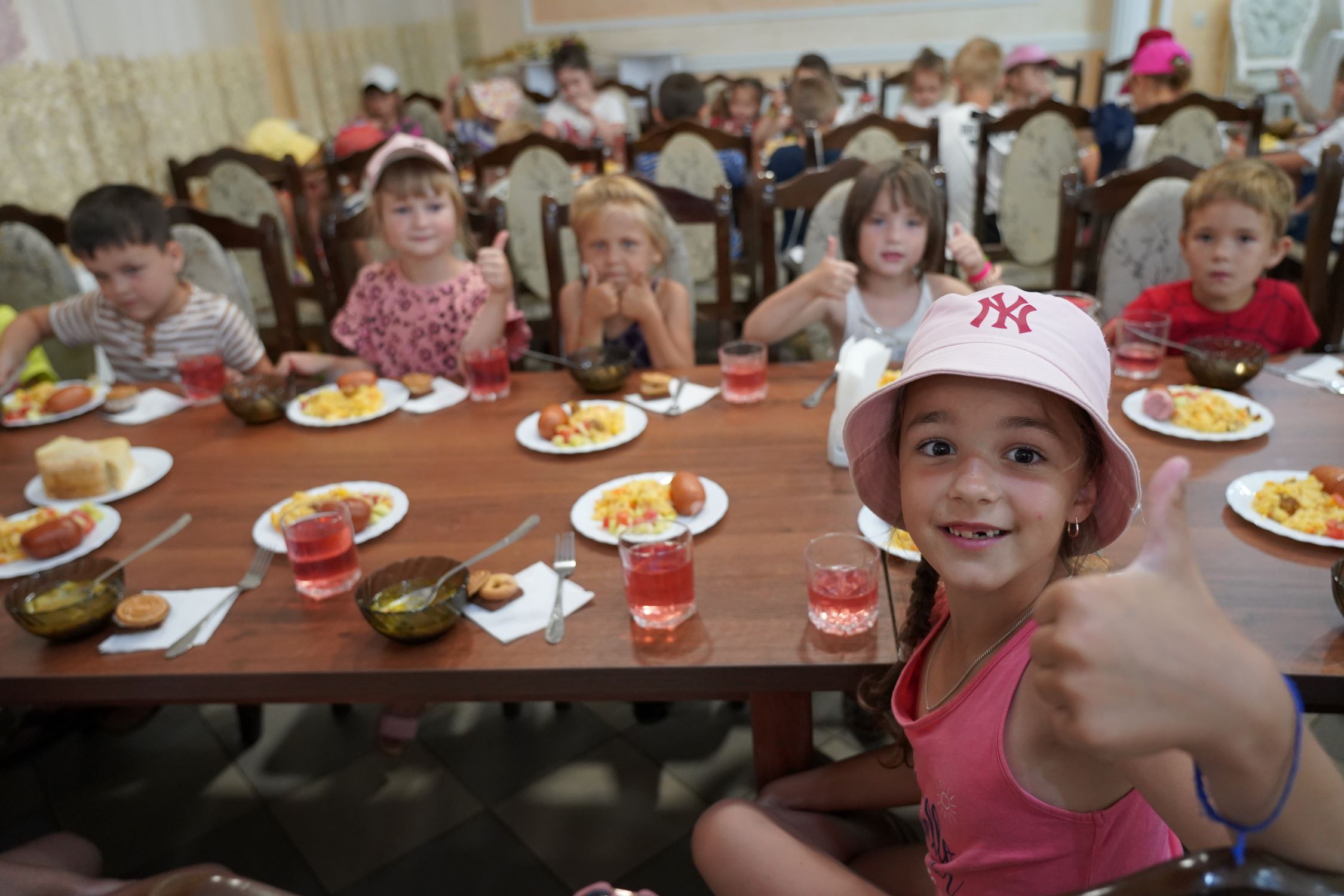 Children in Ukraine enjoying lunch at a summer camp 2022