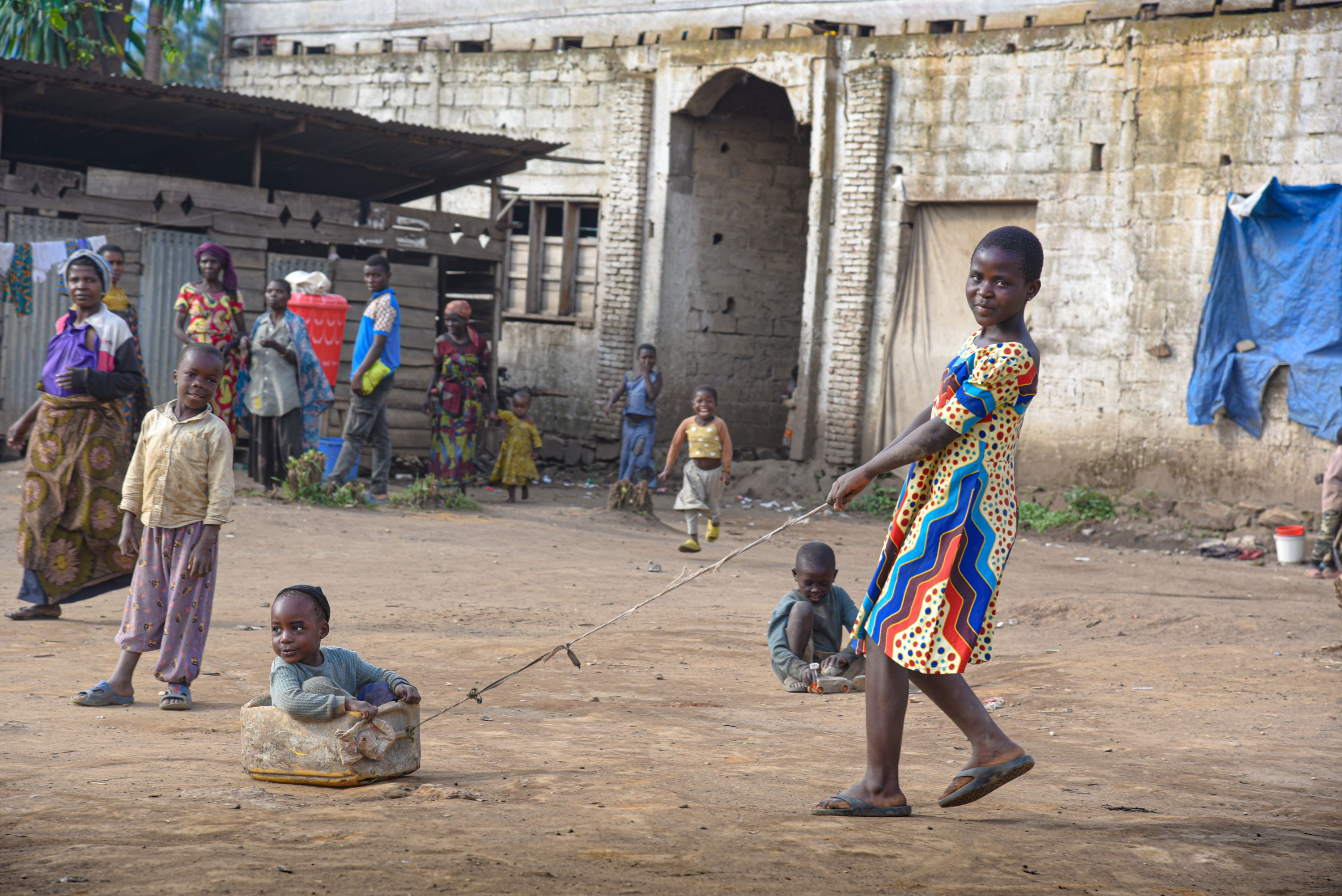 Displaced children, including Noëlla, 12, playing in the street in DRC