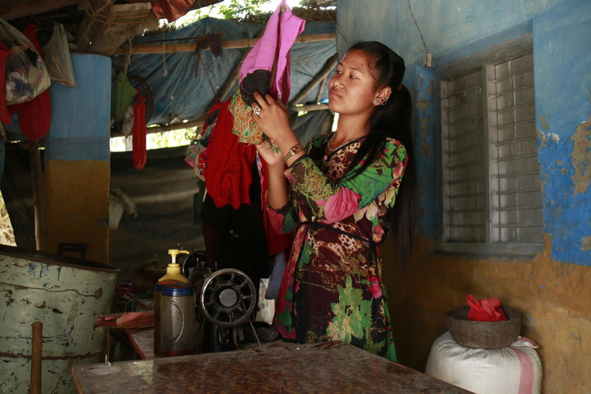 A young woman in Nepal, with a speech impairment, at her tailoring shop.