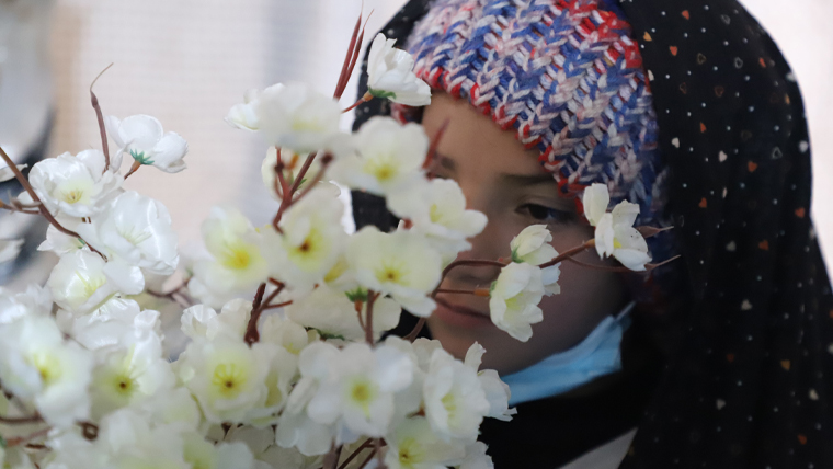 Marian, 11, admires an arrangement of white flowers