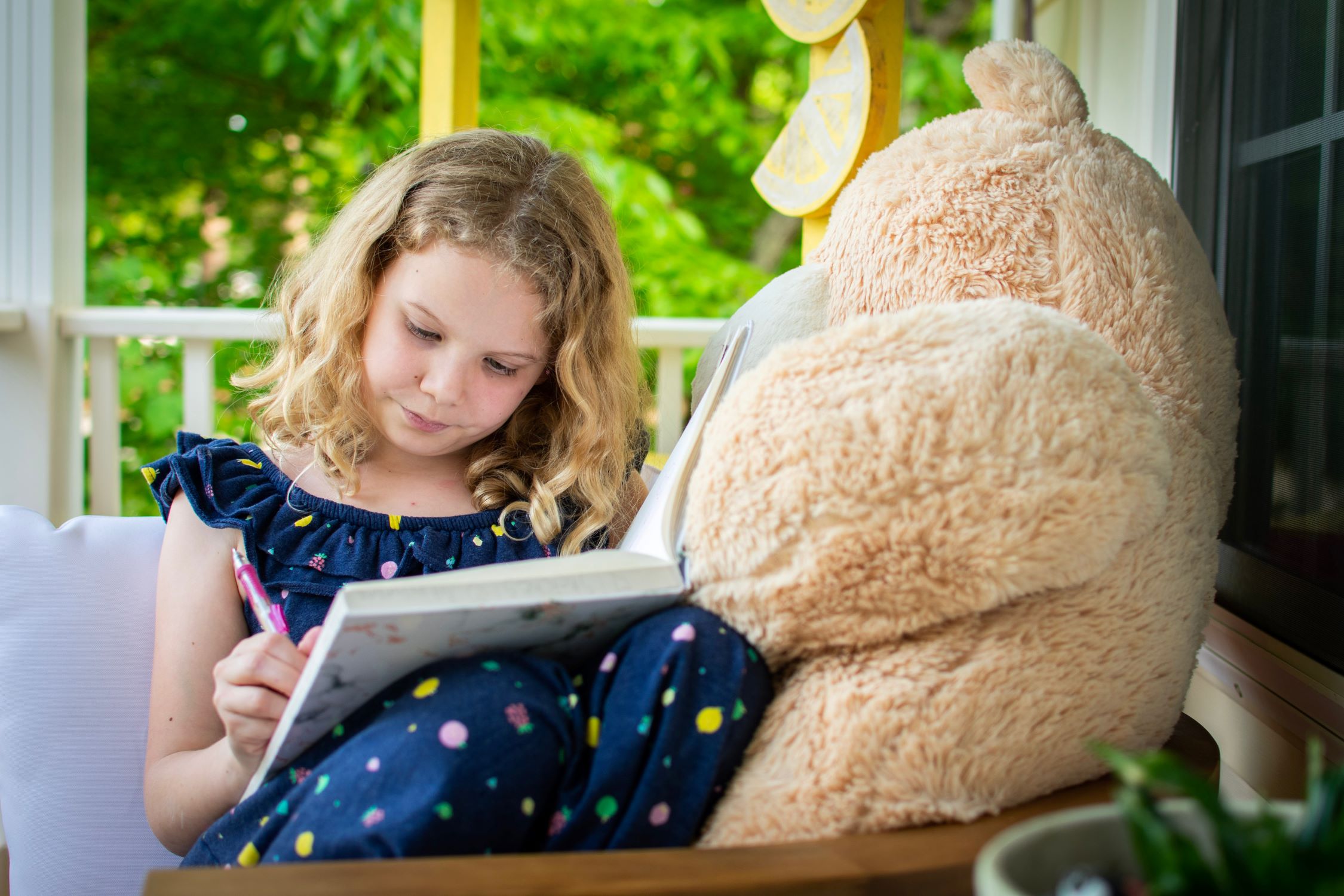 A little girl writing in a journal