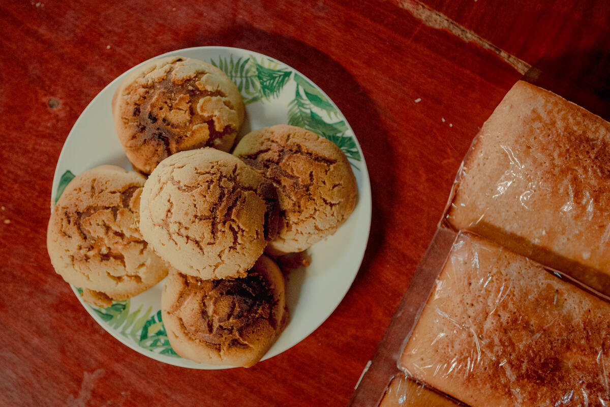 Pictures of baked goods on a plate and some loaves by the side