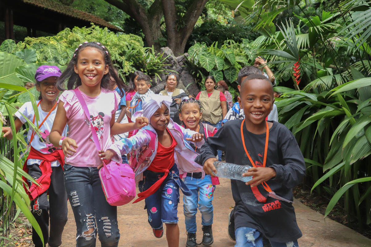 Children in Columbia run towards the camera smiling