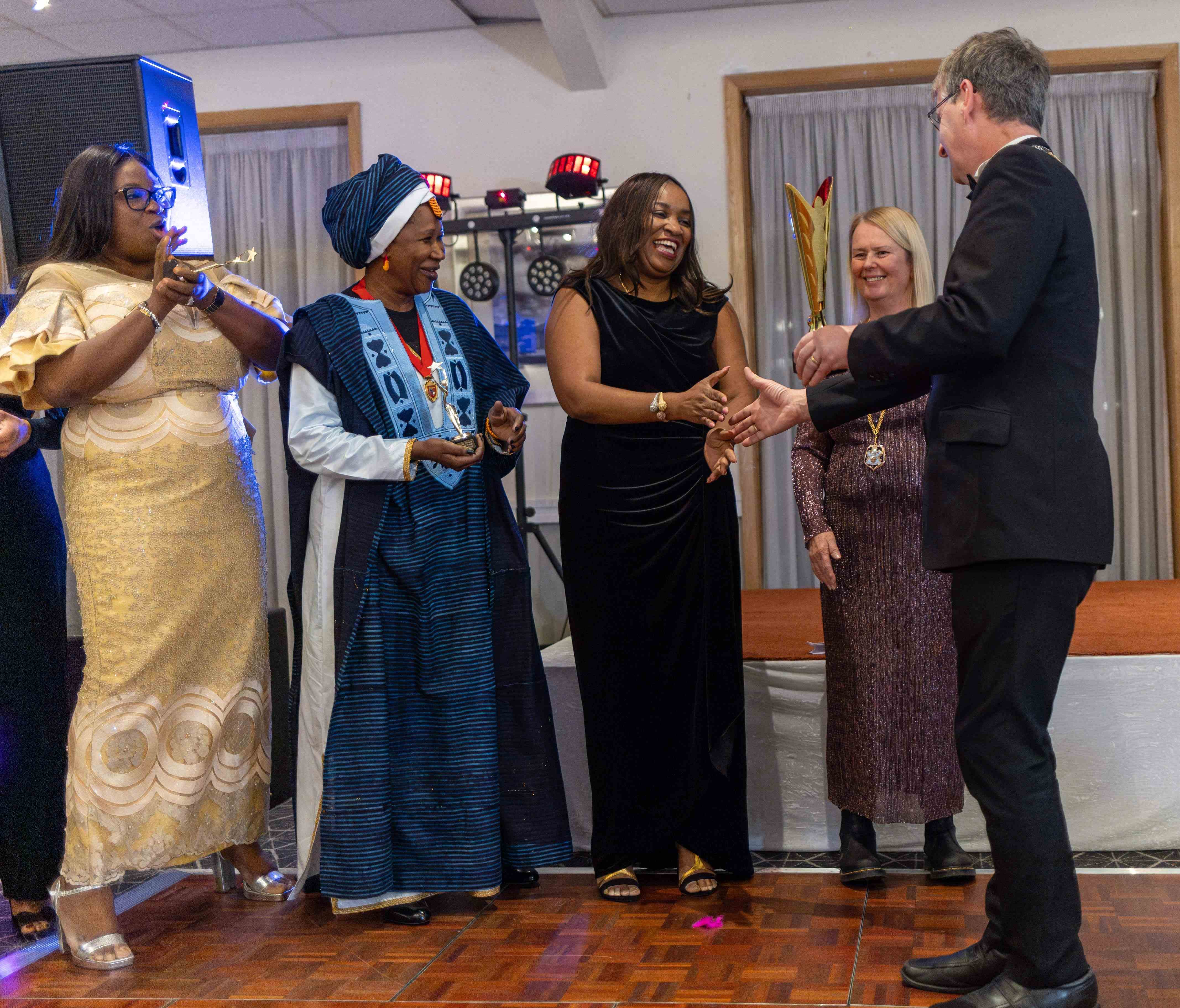 Fola being presented with the award