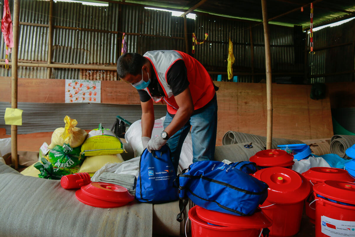 A World Vision Nepal staff manages food supplies and hygiene kit packages to be distributed to people in need