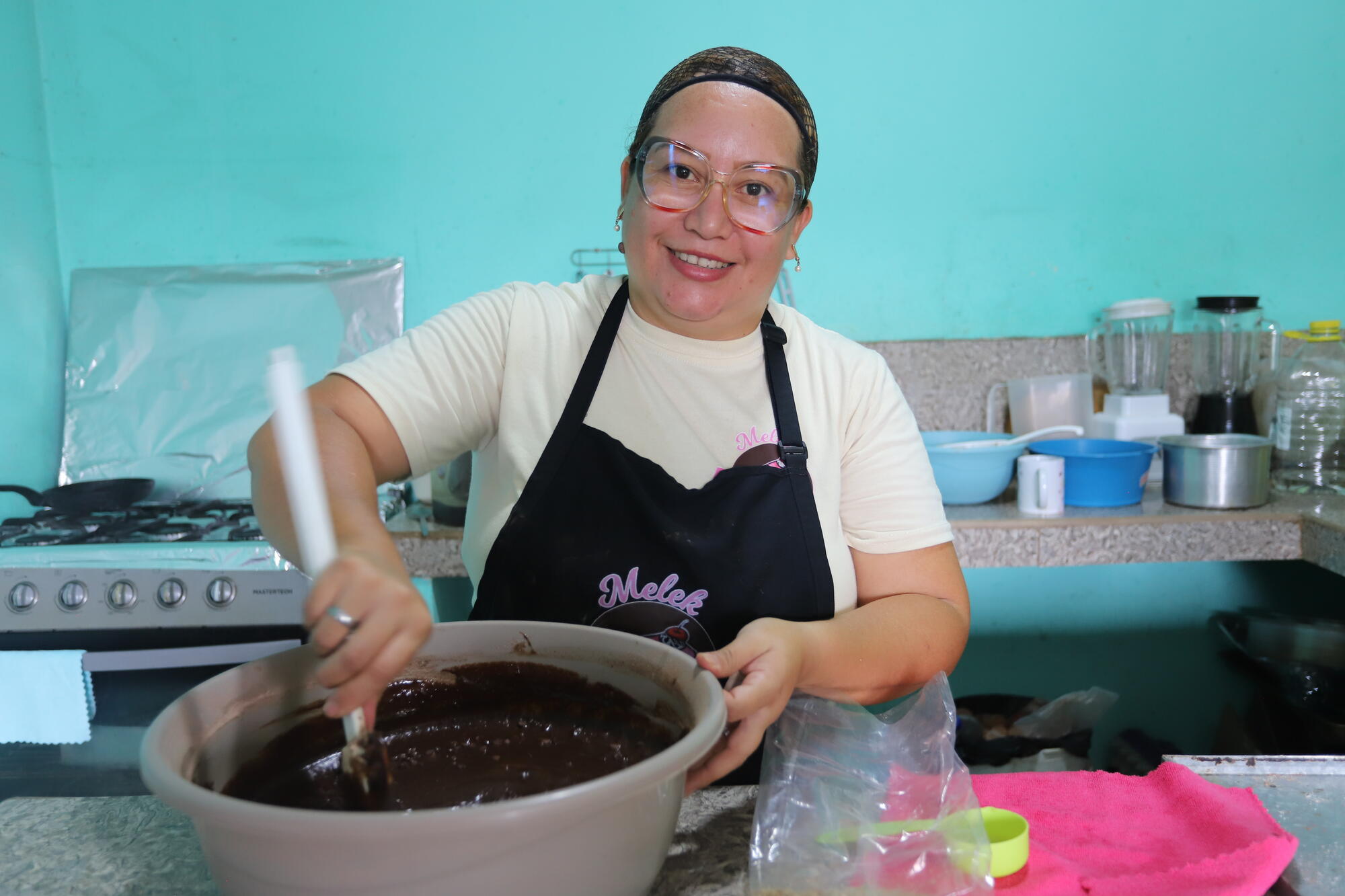 Edianny mixes ingredients in her kitchen