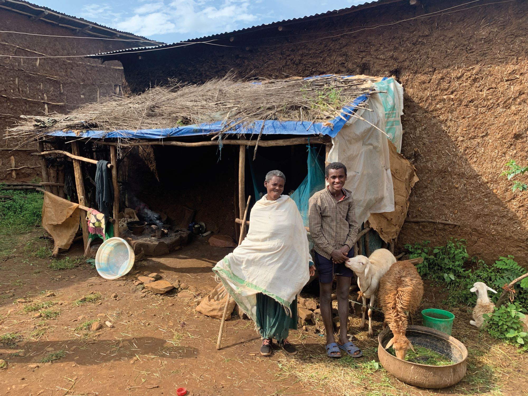 Boy and mother in front of home in Ethiopia