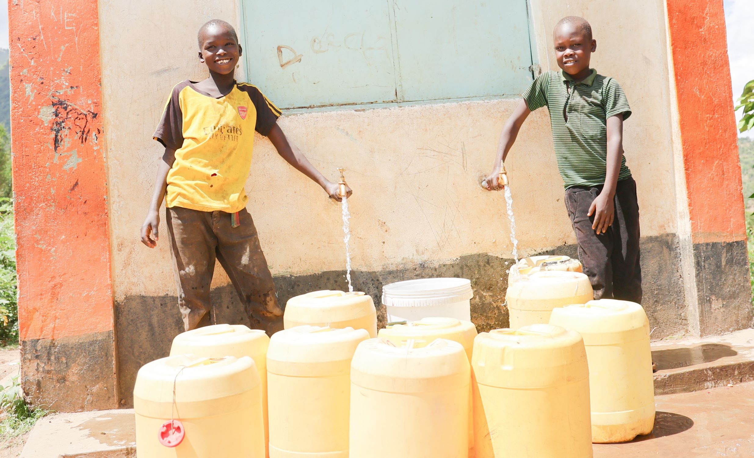 Kenyan boys turning water taps