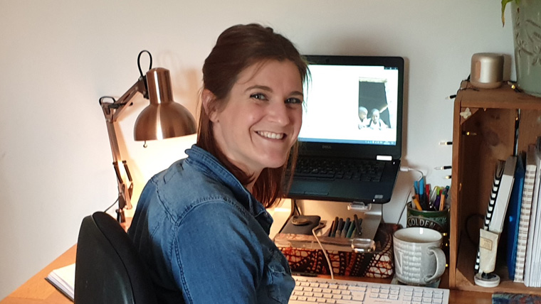 Nina sitting at her desk