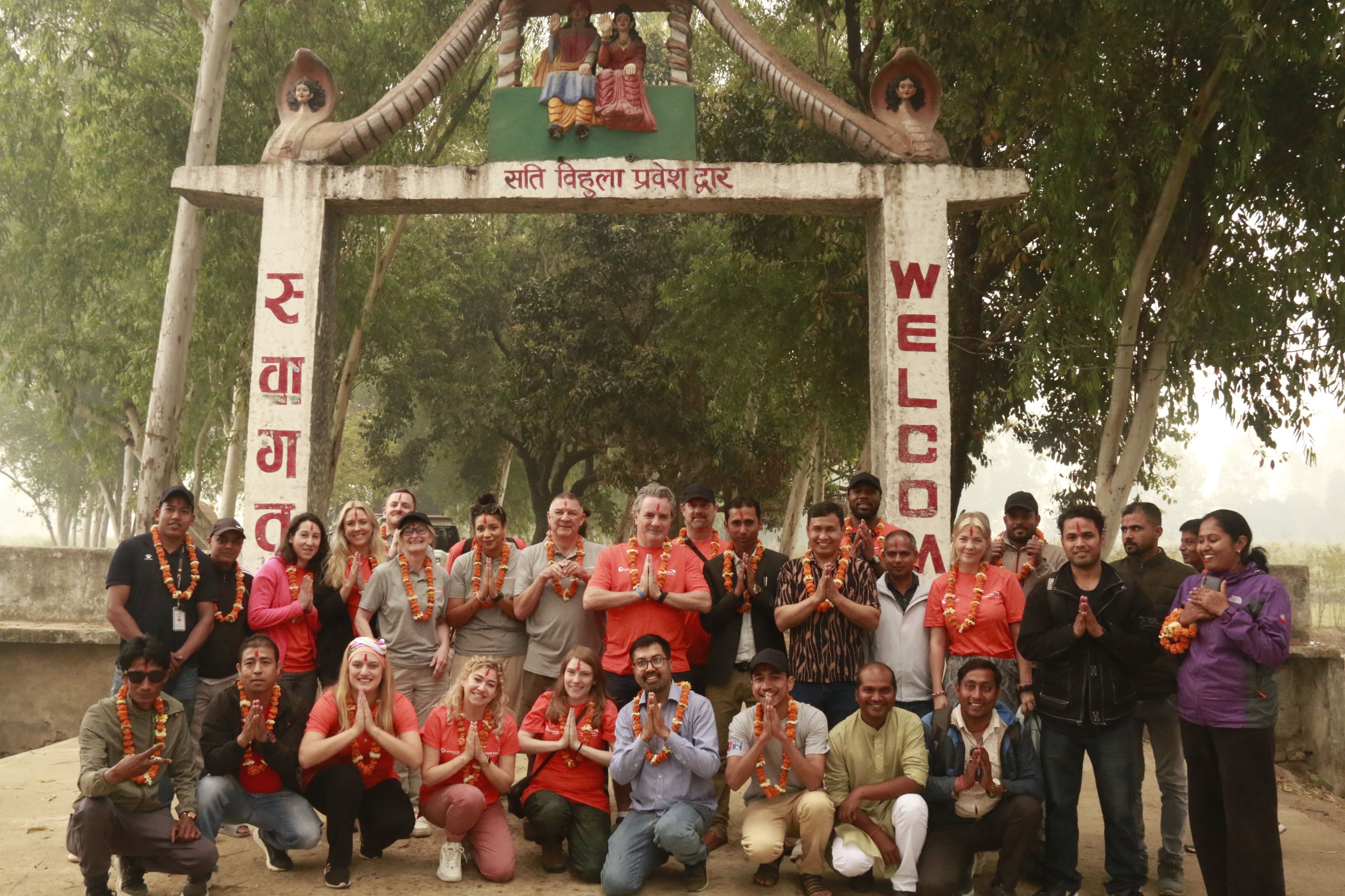 WVUK and Lightsource stand together in front of Welcome gate