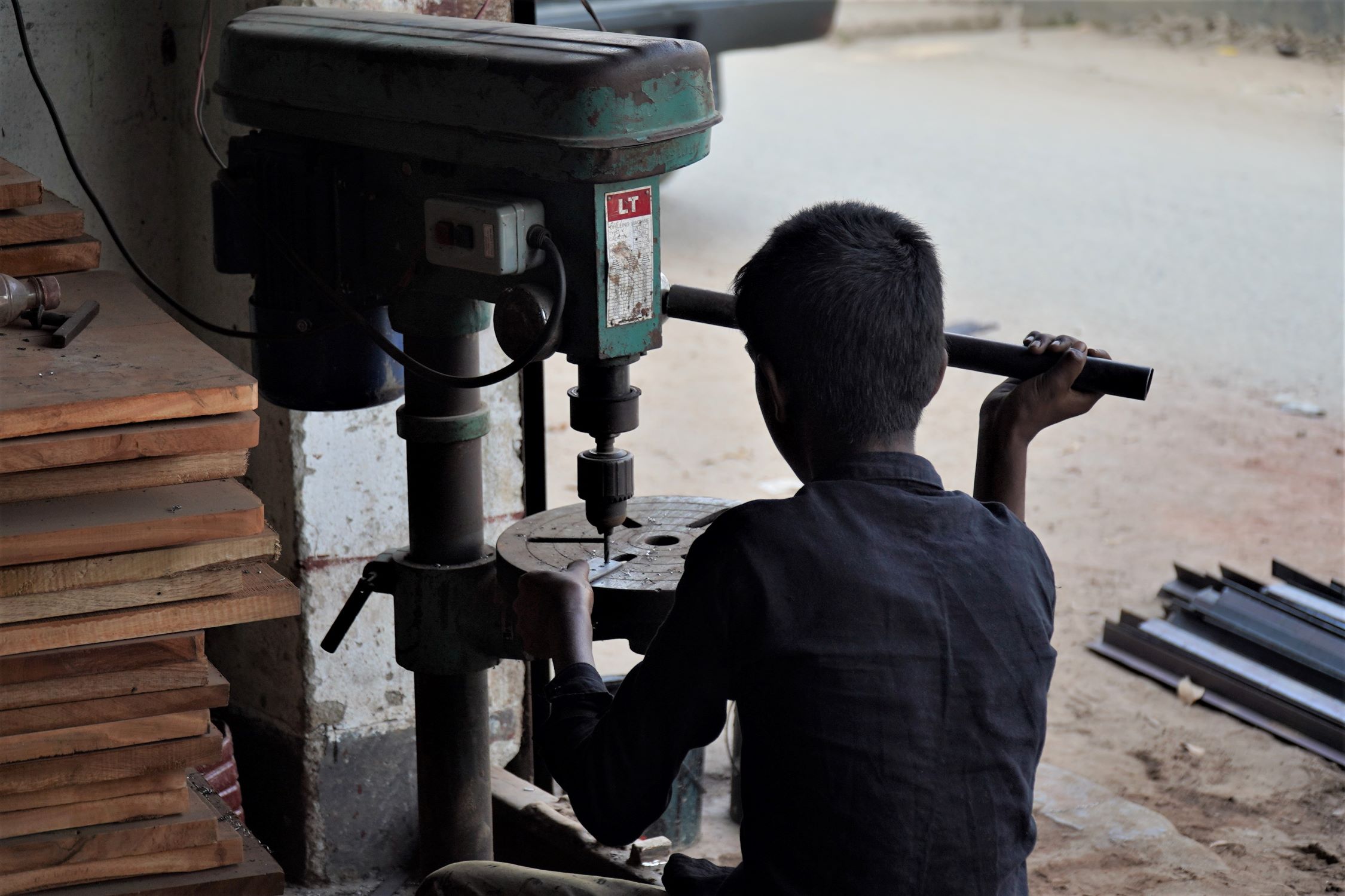 Boy handling machinery