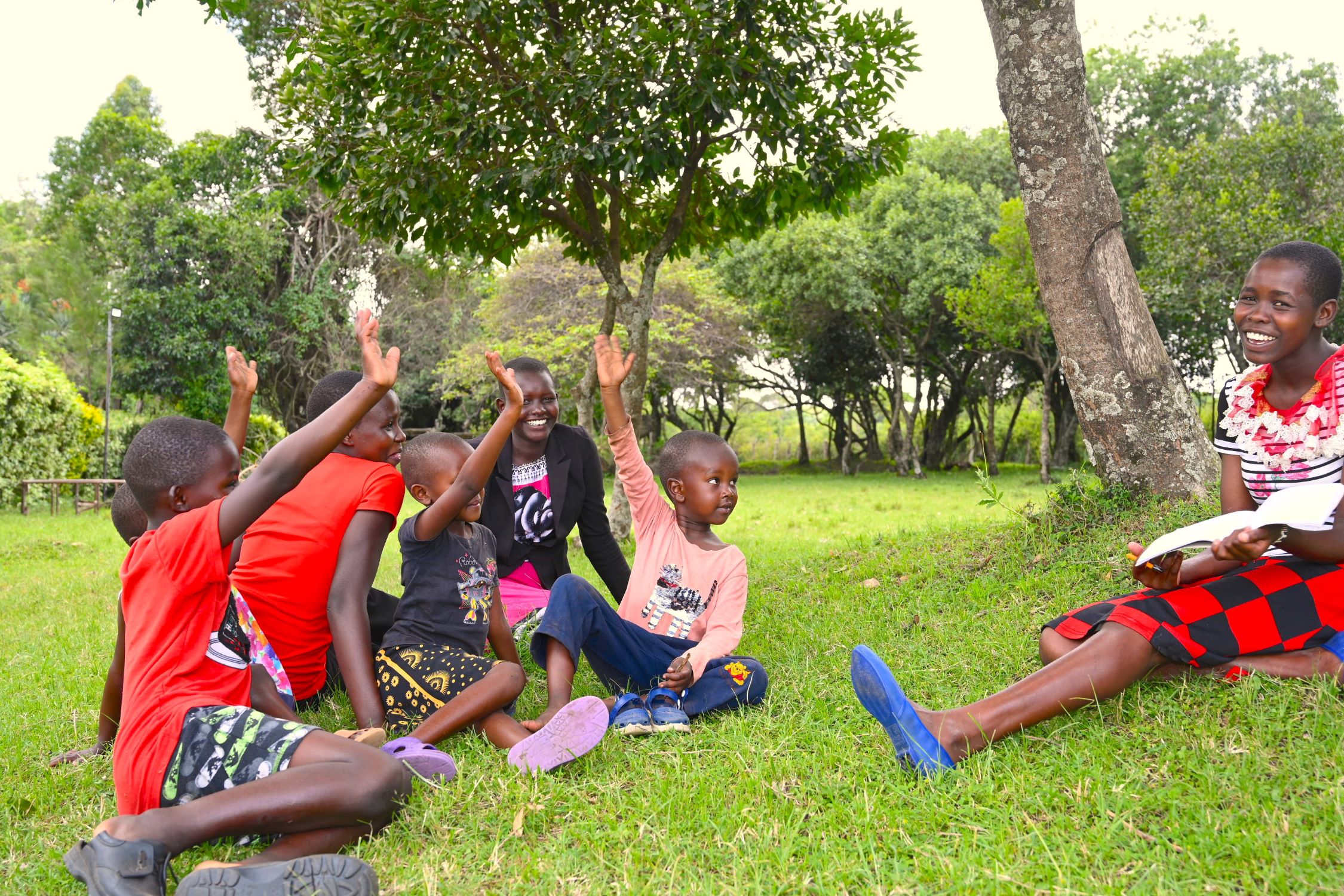 Children in Kenya raising hands