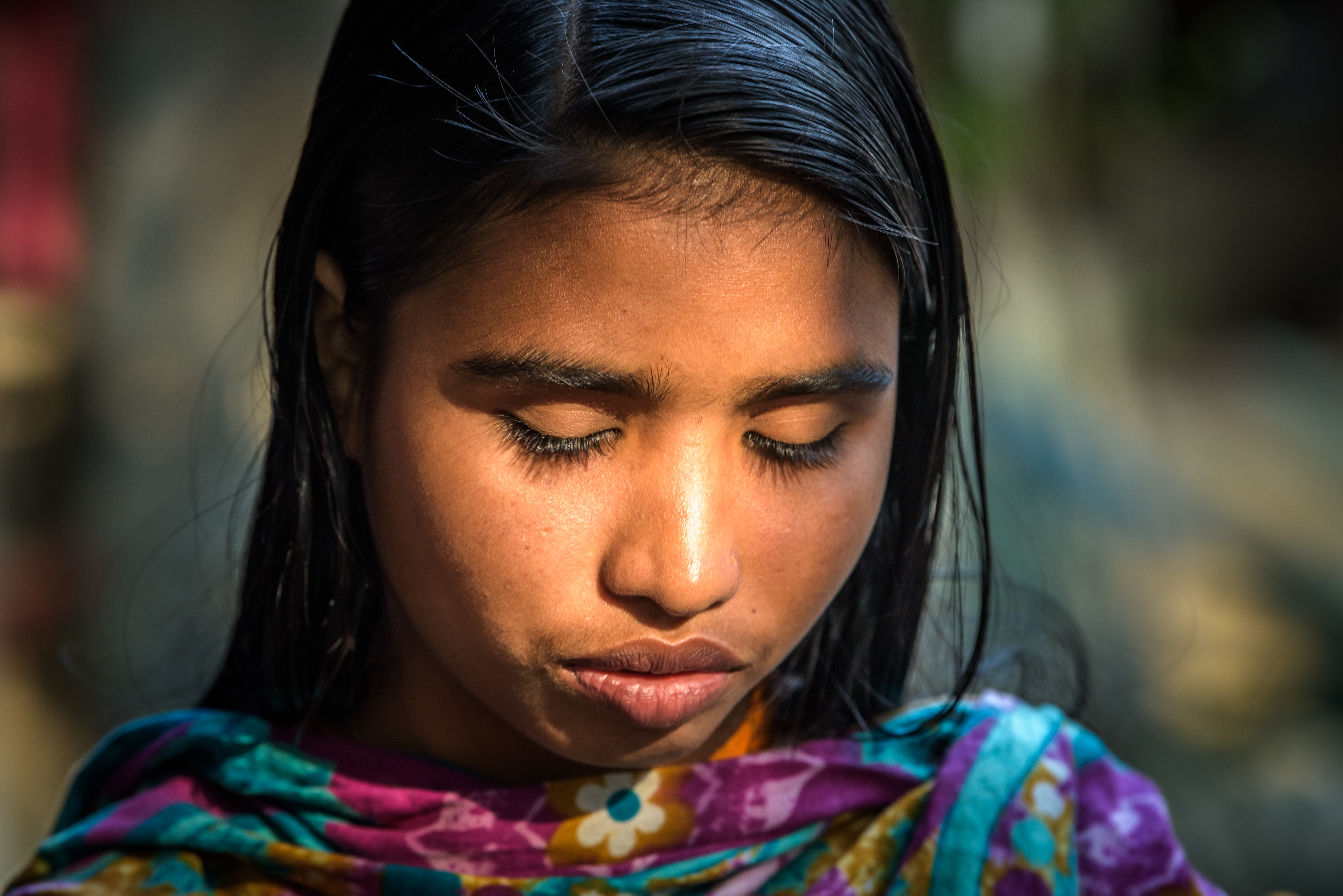 A girl in India looks down as child marriage is discussed