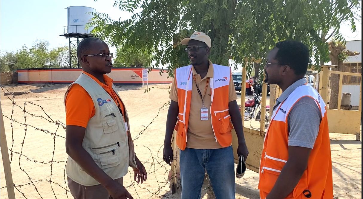 Three World Vision staff members talking in Sudan