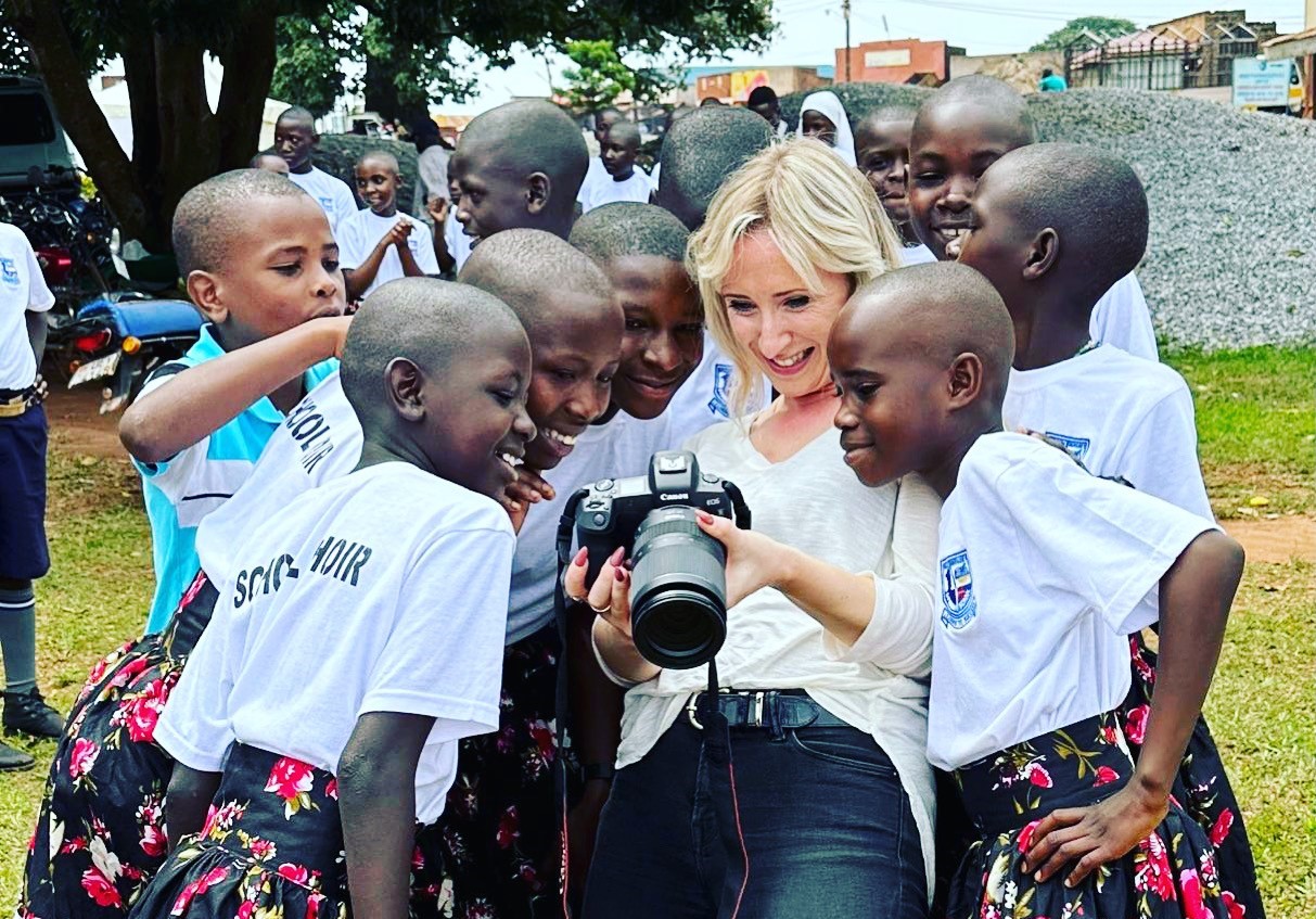 School children looking at pictures on a camera
