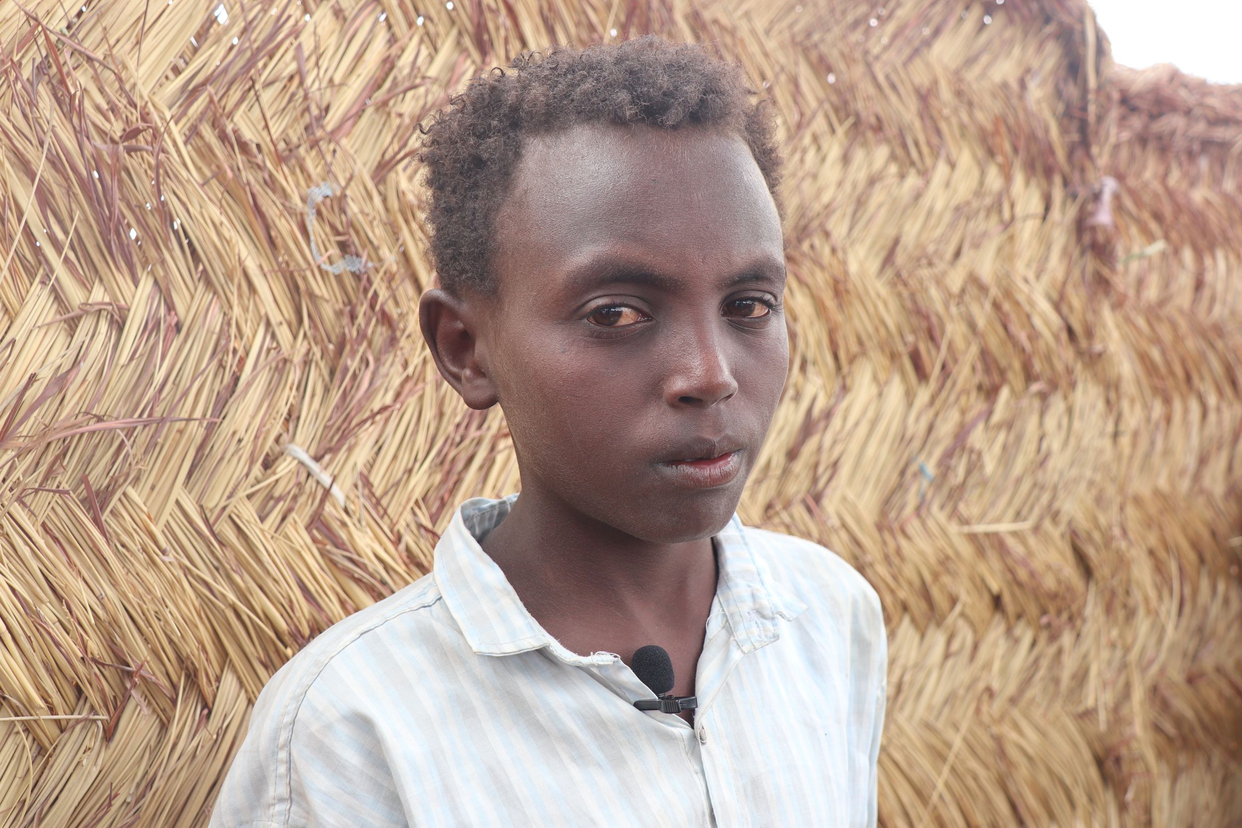 Sudanese boy in light stripy shirt