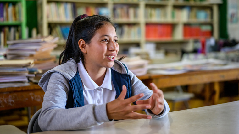 Nahomy sits in her book-lined classroom, and talks about the difference sponsorship has made to her life