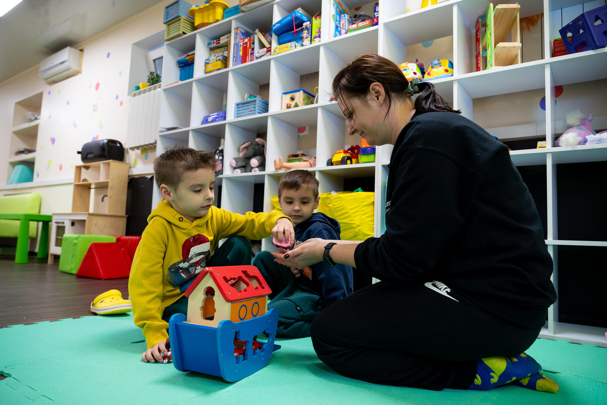 Two children play with toys at a children's centre in Ukraine