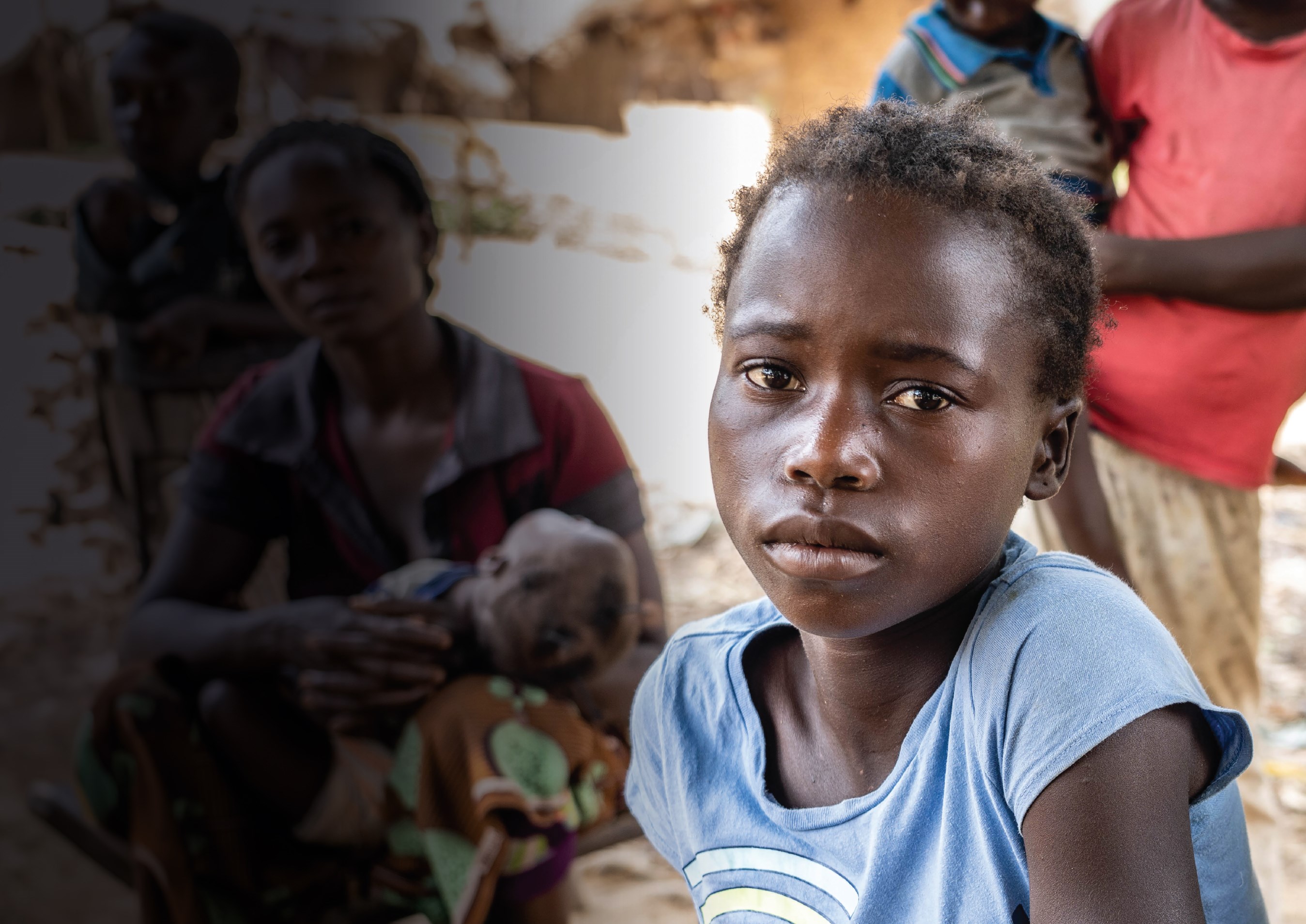 A displaced child stares at the camera