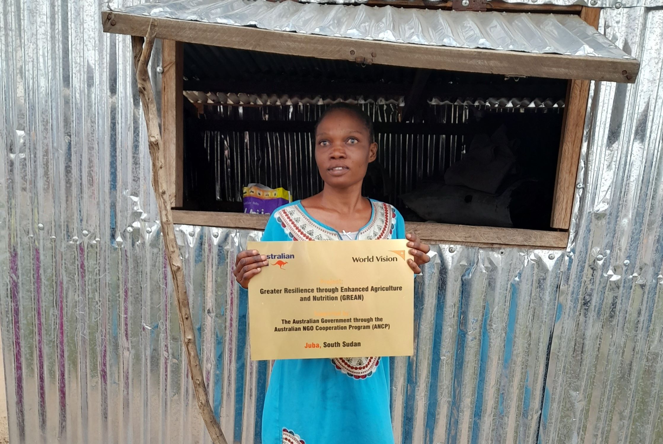 South Sudan woman outside her shop