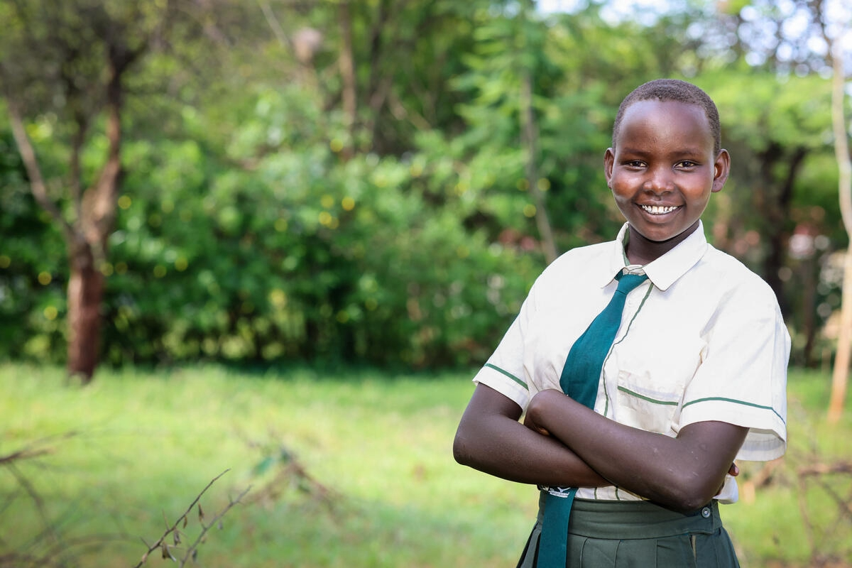 Abigael poses for a photo, she's wearing her uniform
