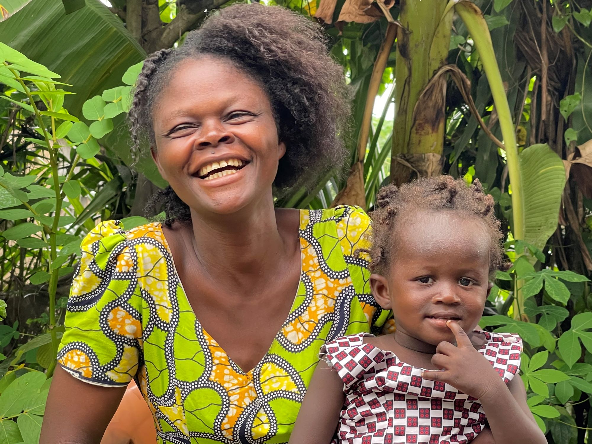DRC mother in green, smiling with her daughter