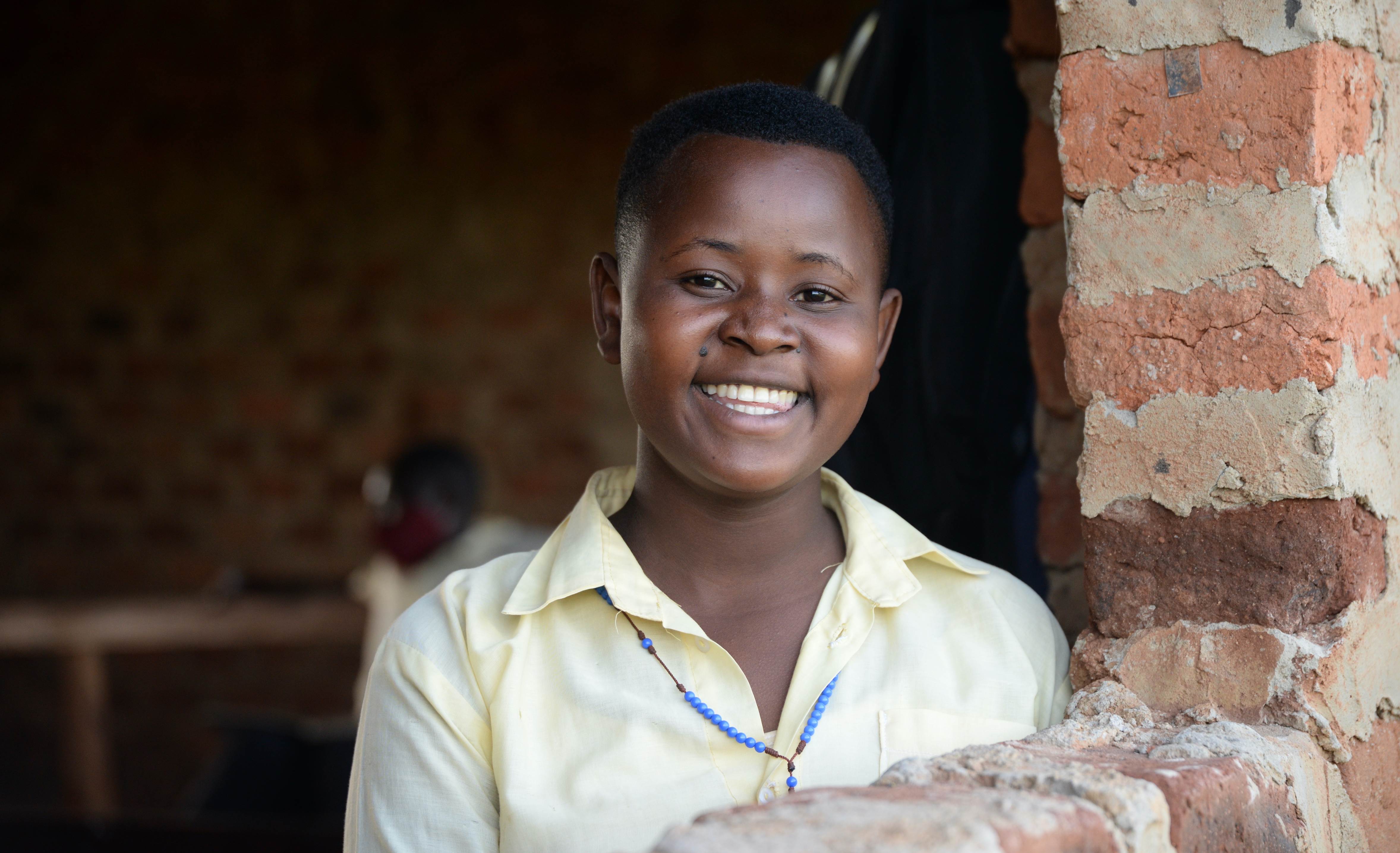 Juliet stands at a window, smiling