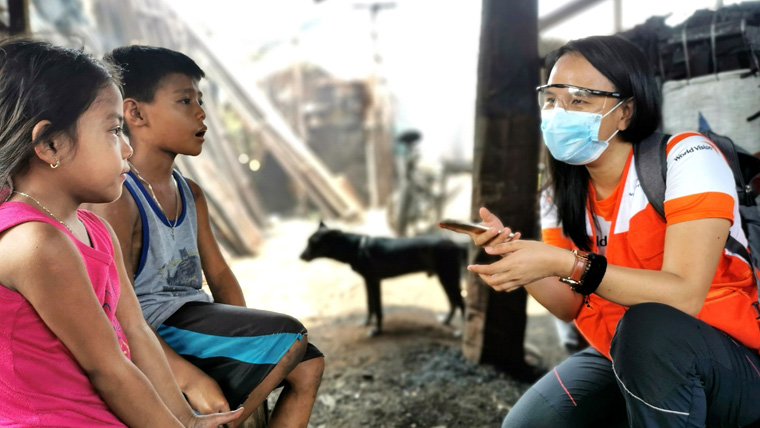 World Vision's Joy with two children