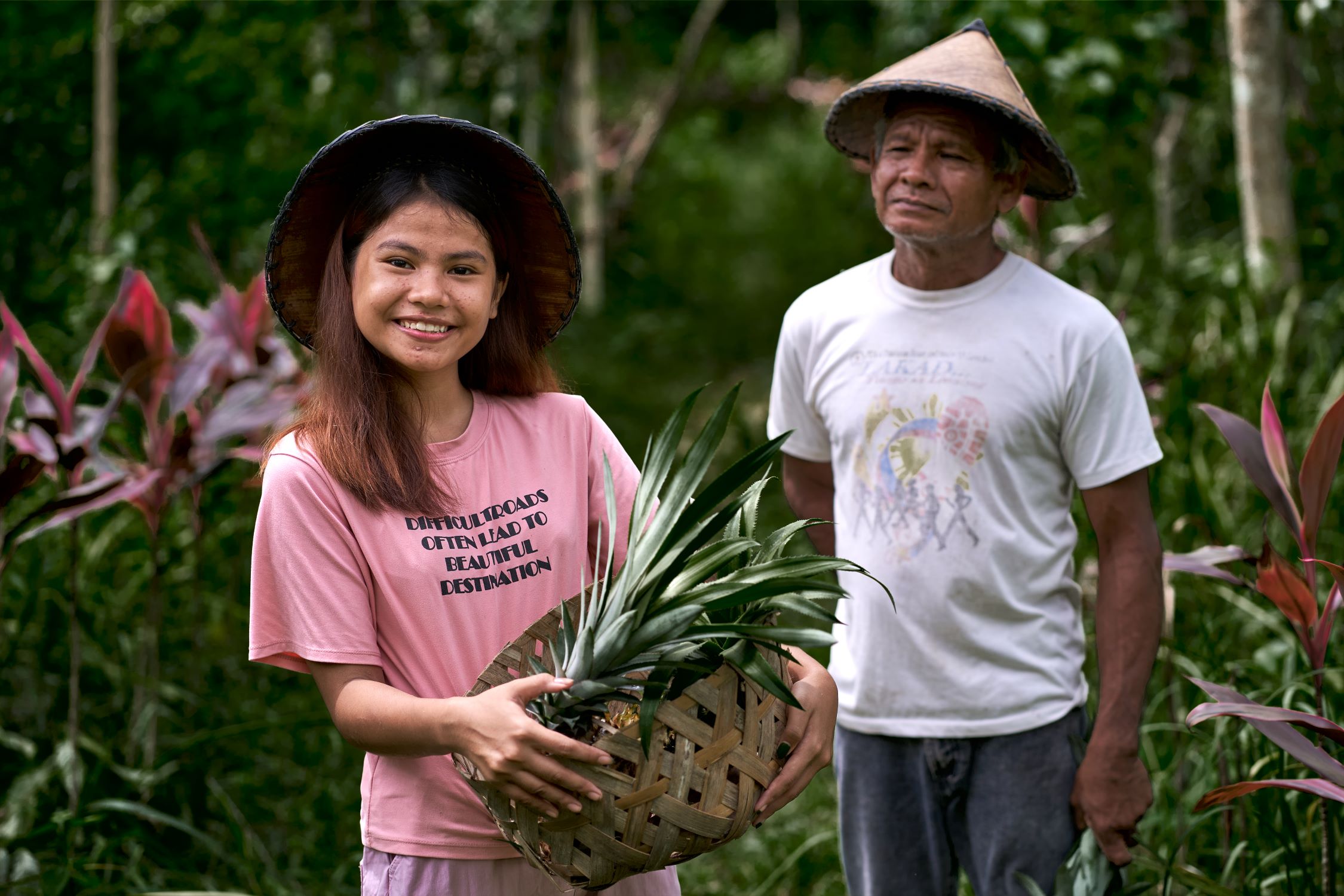 A teenage girl holds the produce she has grown