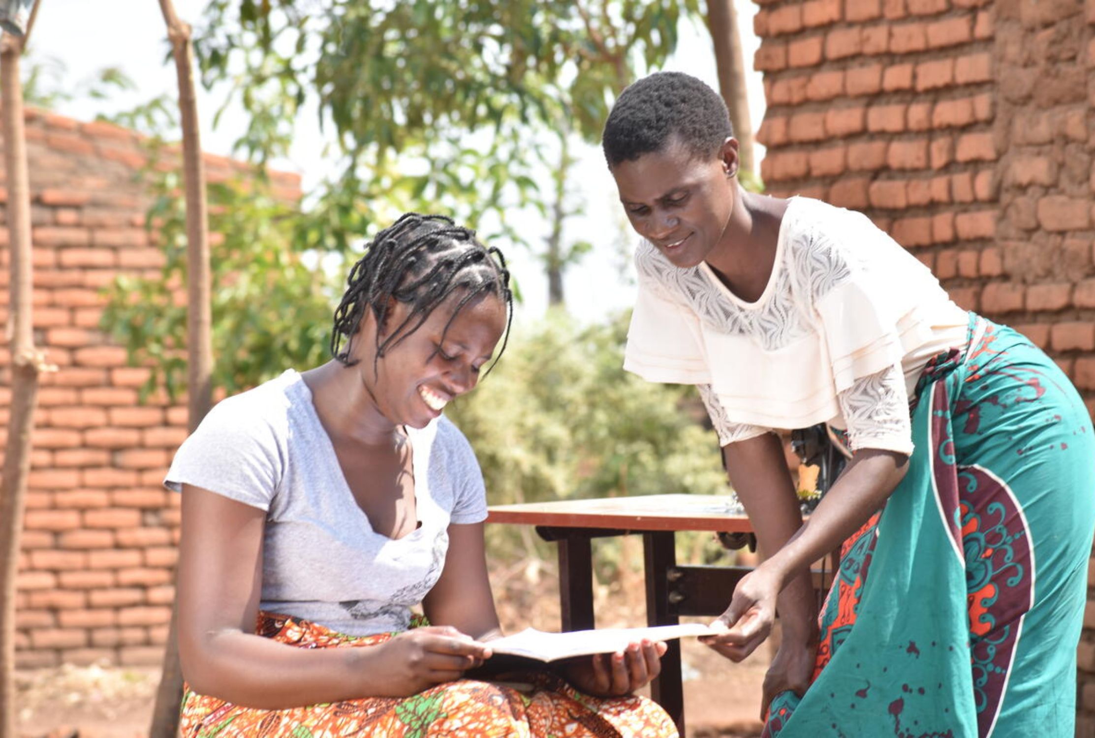 A teenager from Malawi smiles with her mother