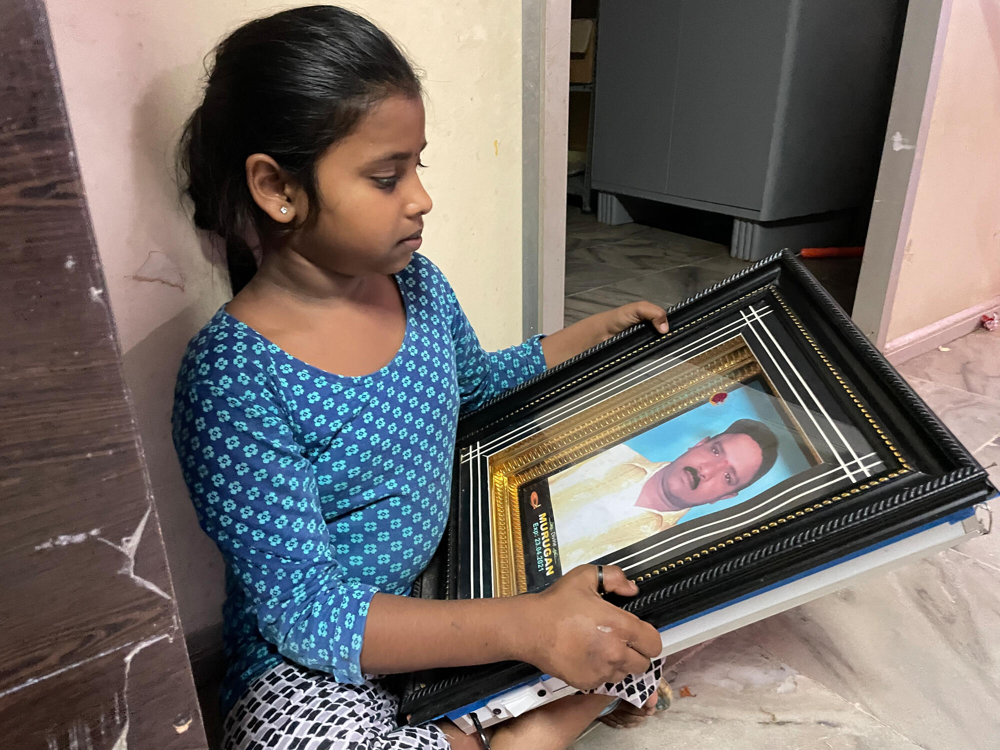 Ashmitha with a photo of her dad