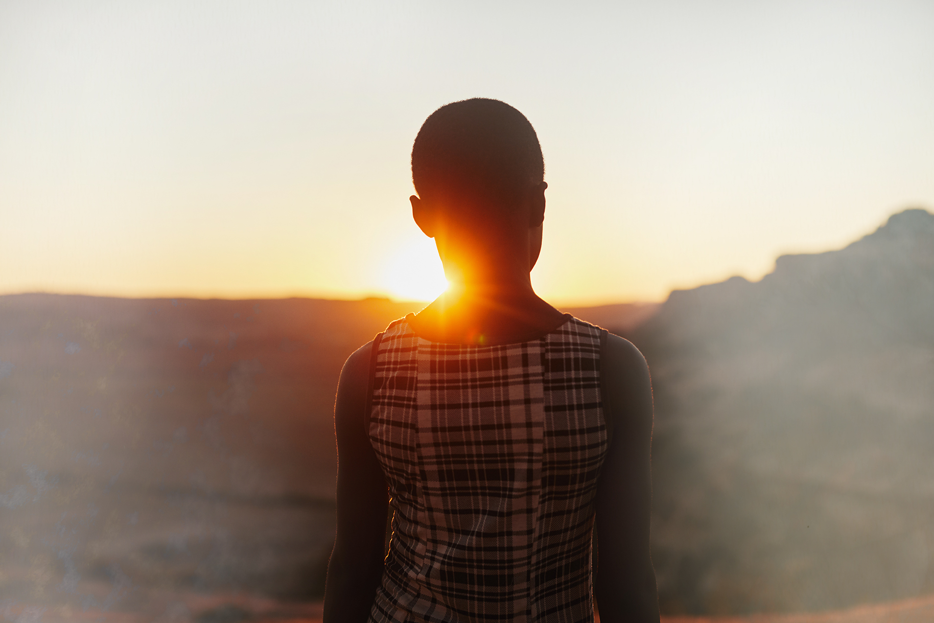 Silhouette of a child with low sun glare behind