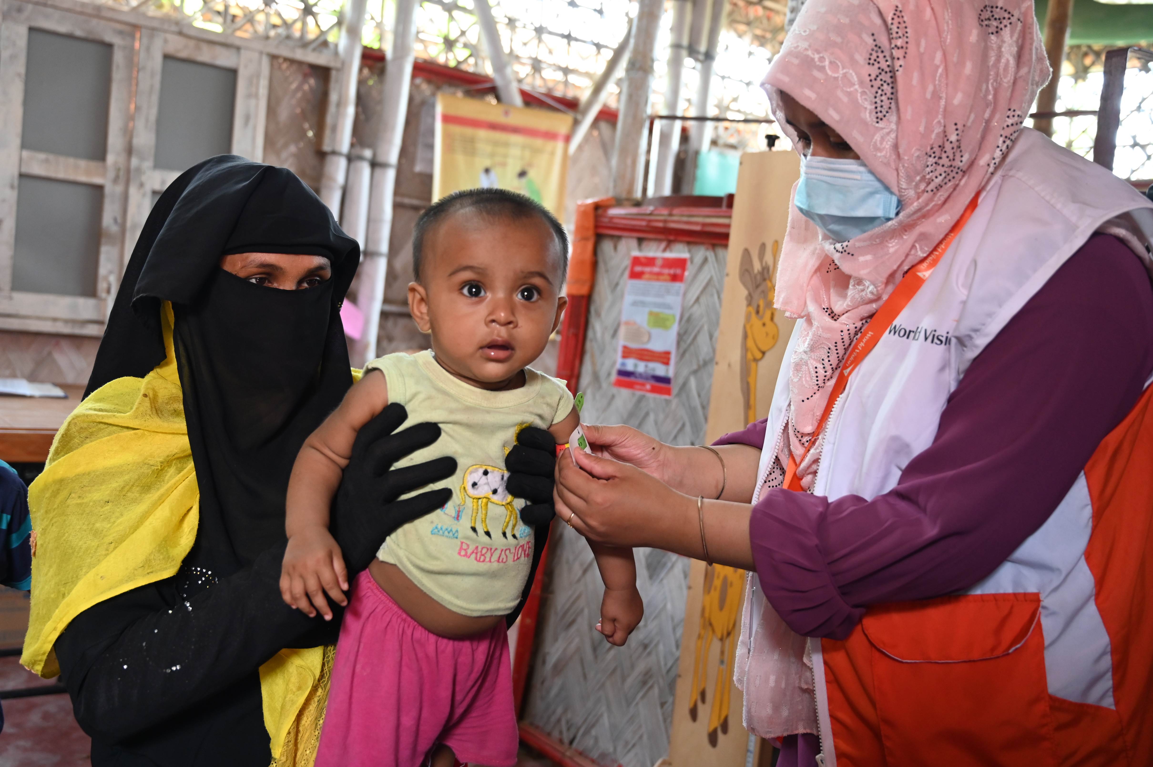 Young girl having her arm circumference measured